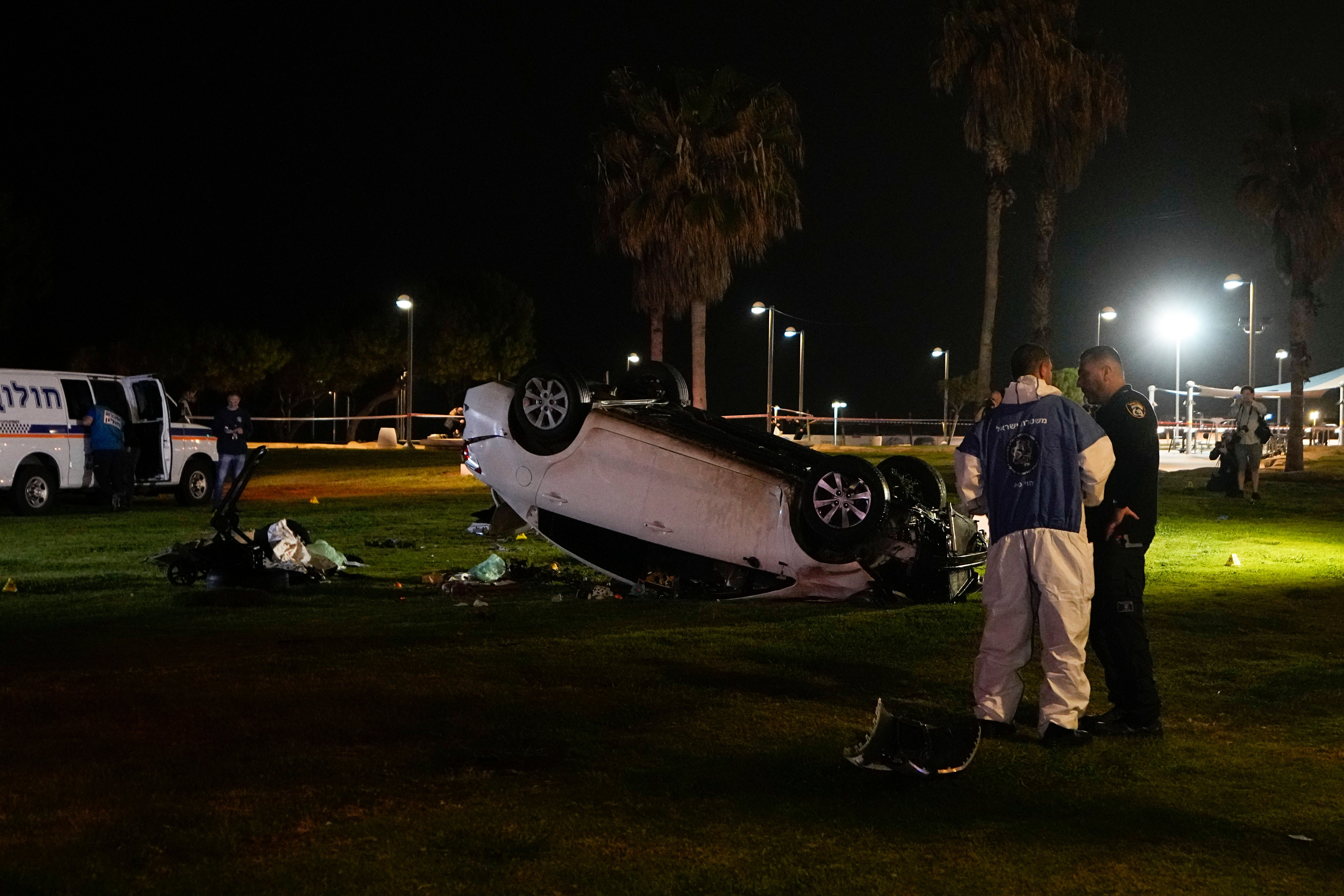 Israeli police stand at the scene of an attack in Tel Aviv (Ariel Schalit/AP)