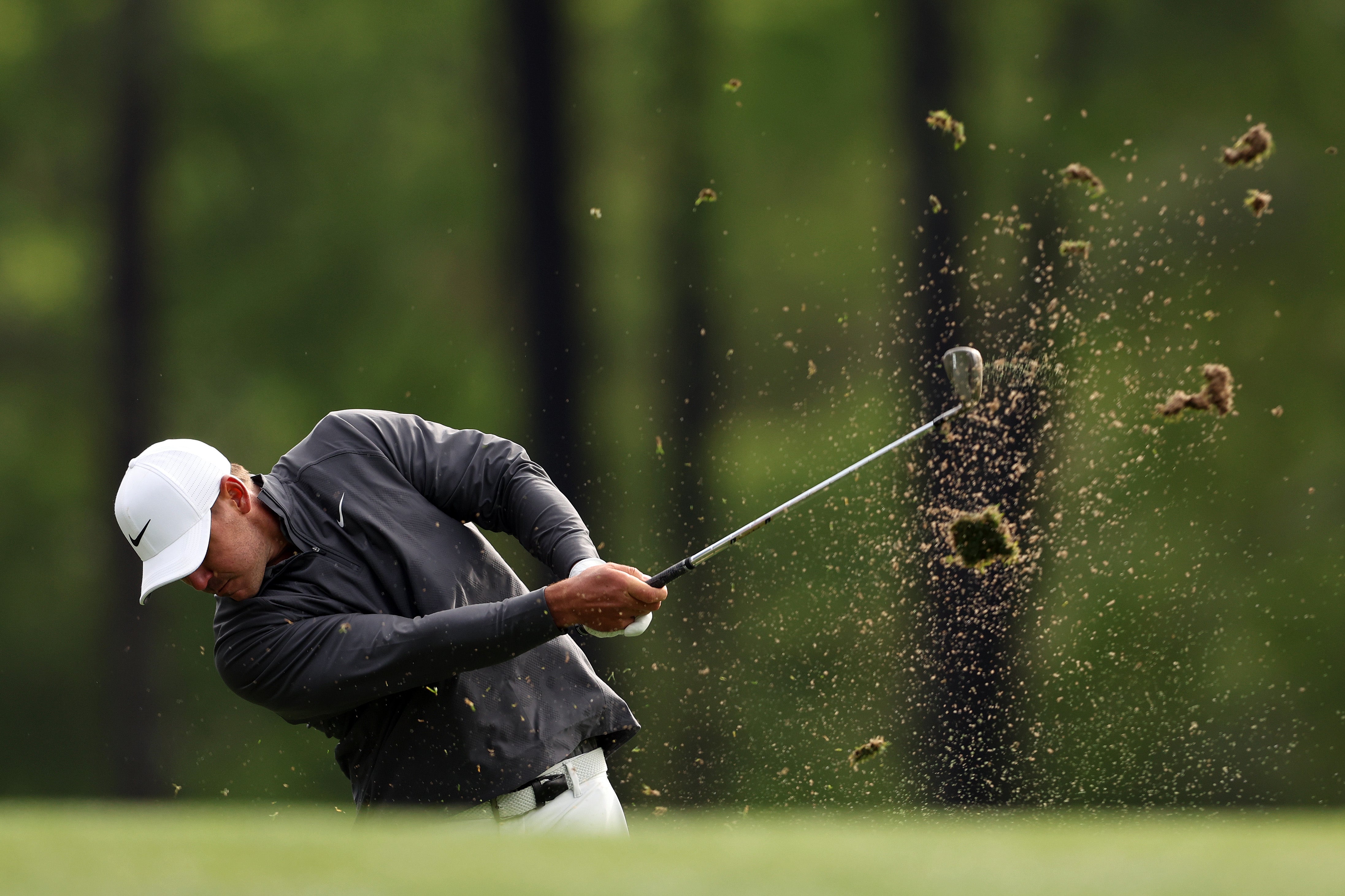 Koepka hits his tee shot on the par-three 12th hole