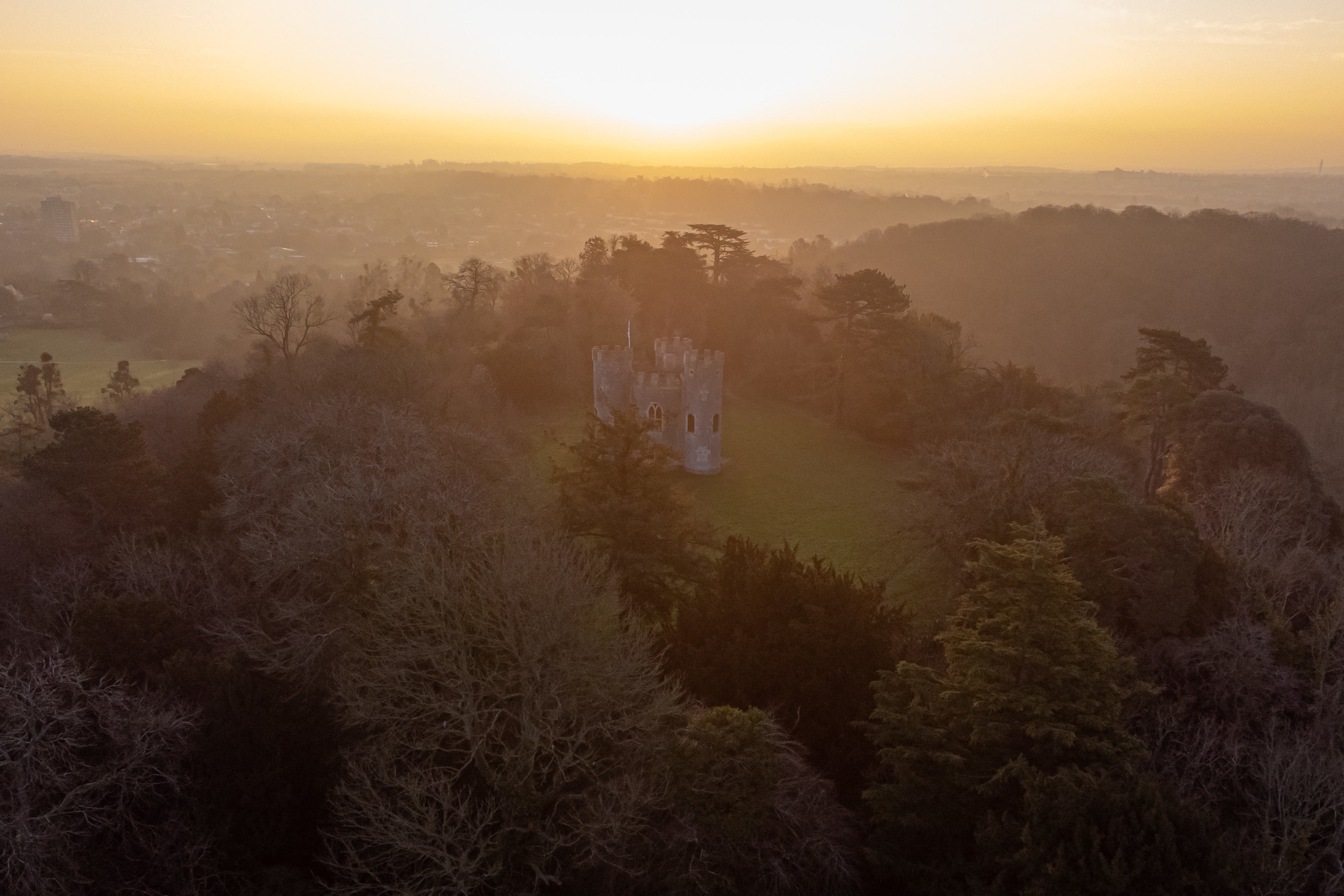 A hazy sun rises over Blaise Castle estate in Bristol