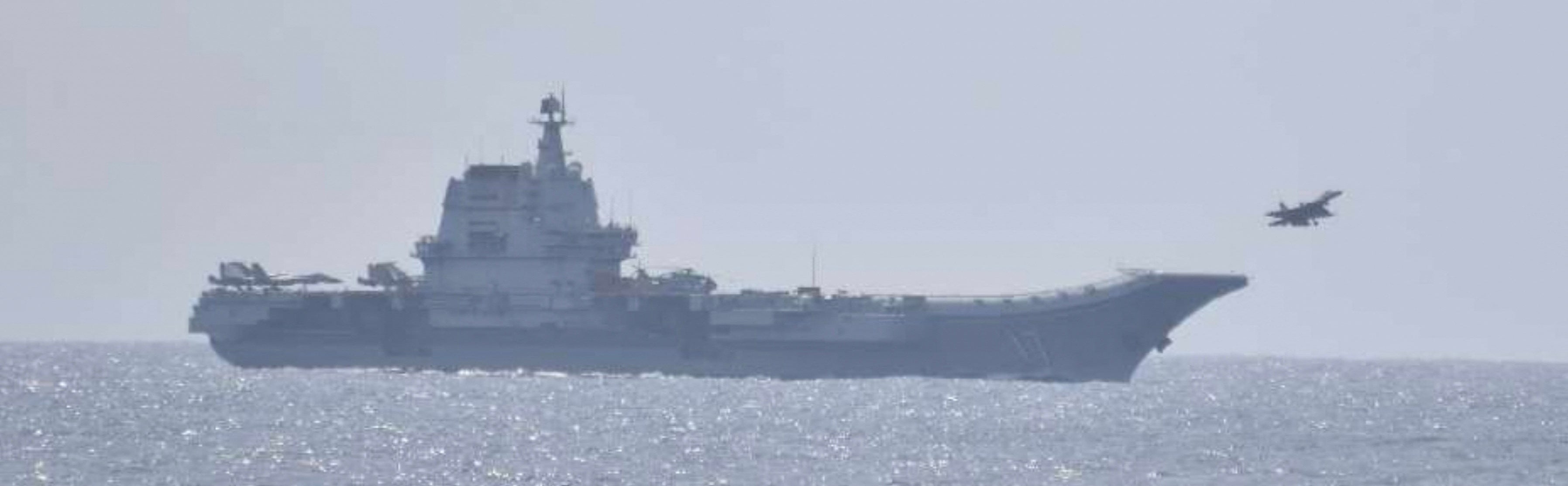 A jet fighter takes off from China’s Shandong aircraft carrier, over Pacific Ocean waters