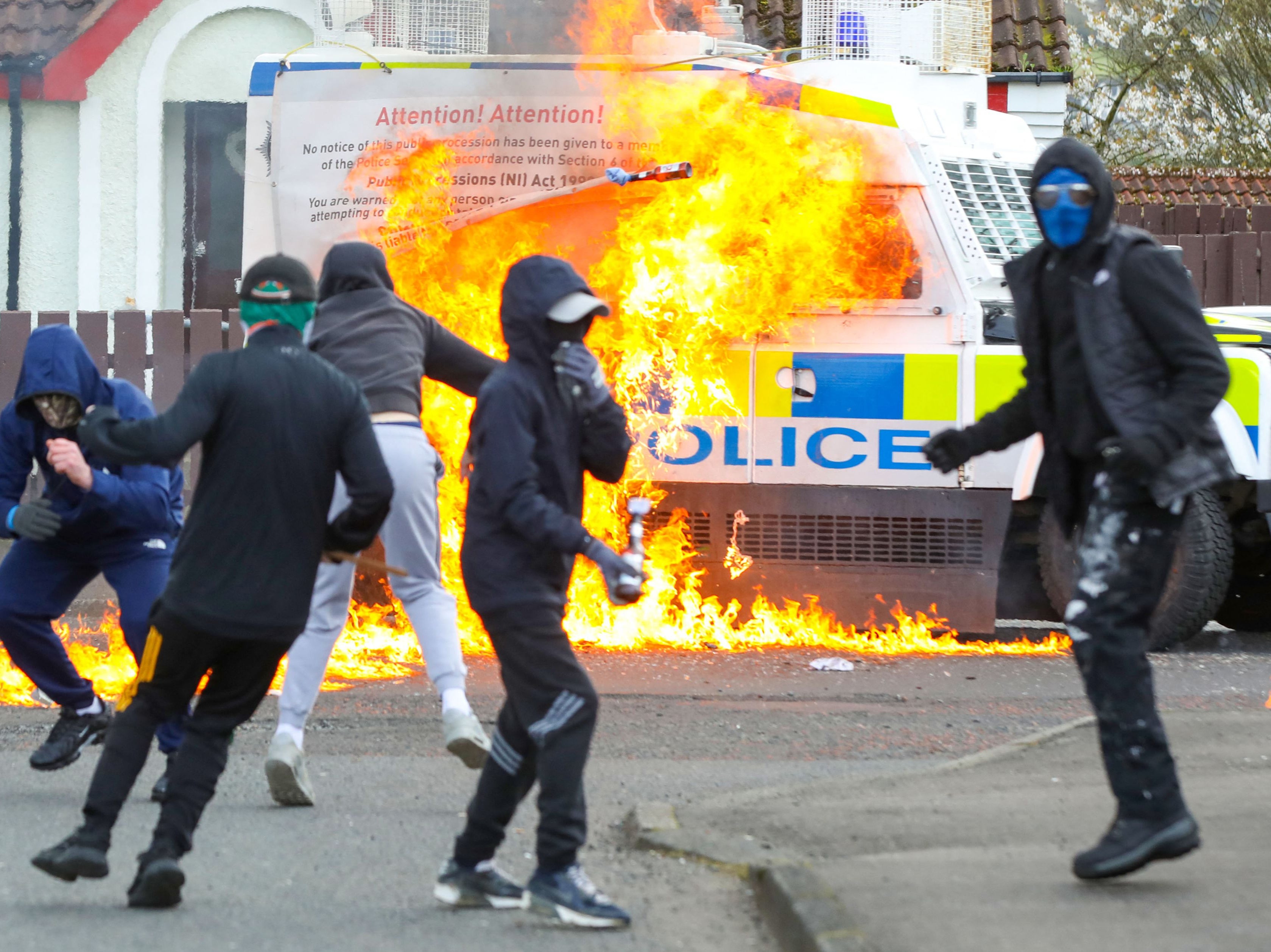 Masked youths attack a police vehicle with petrol bombs in Derry’s Creggan area