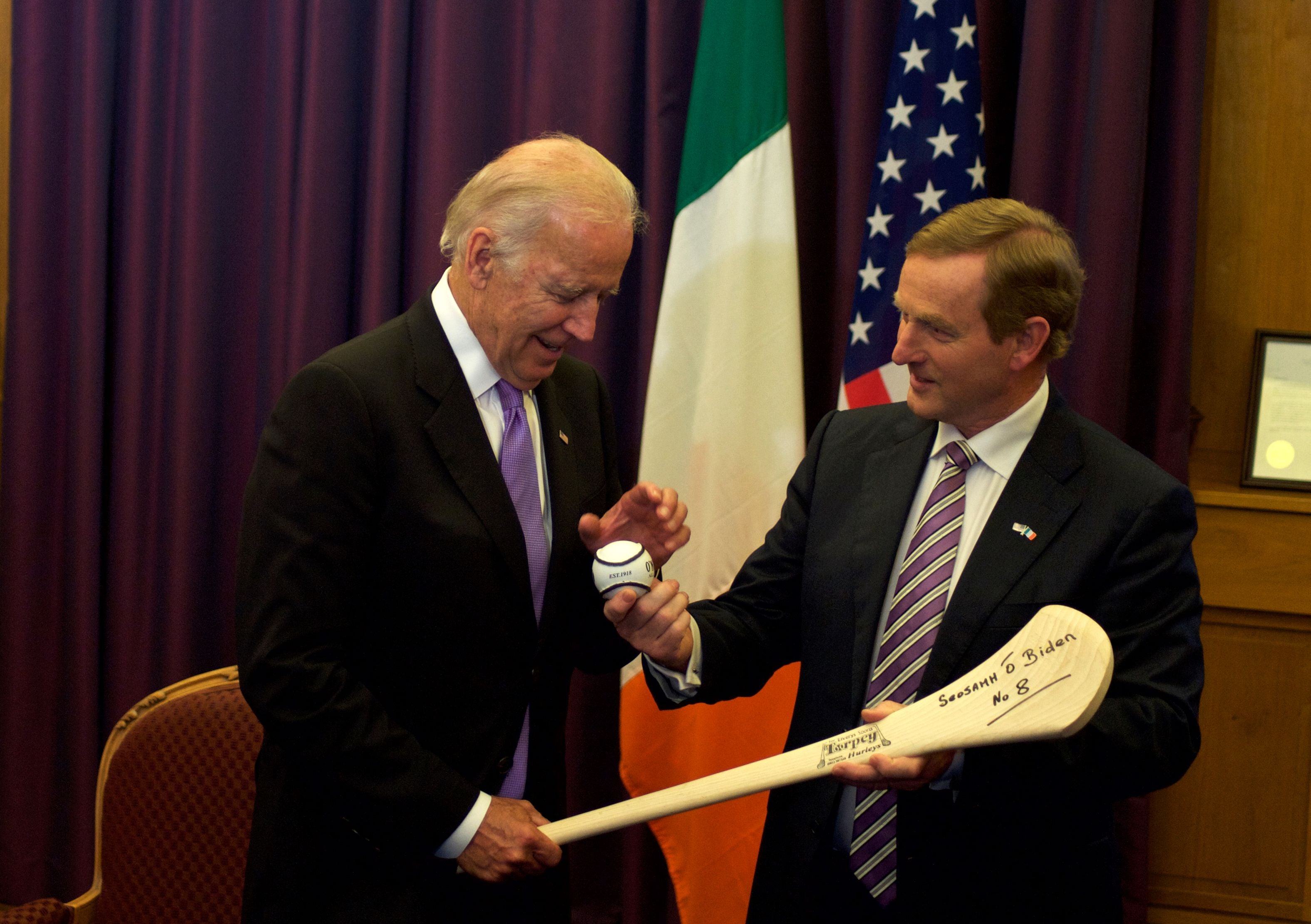 US vice-president Joe Biden receives a hurl as a welcome gift from Irish prime minister Enda Kenny during a welcome ceremony at the Government Buildings in Dublin in 2016