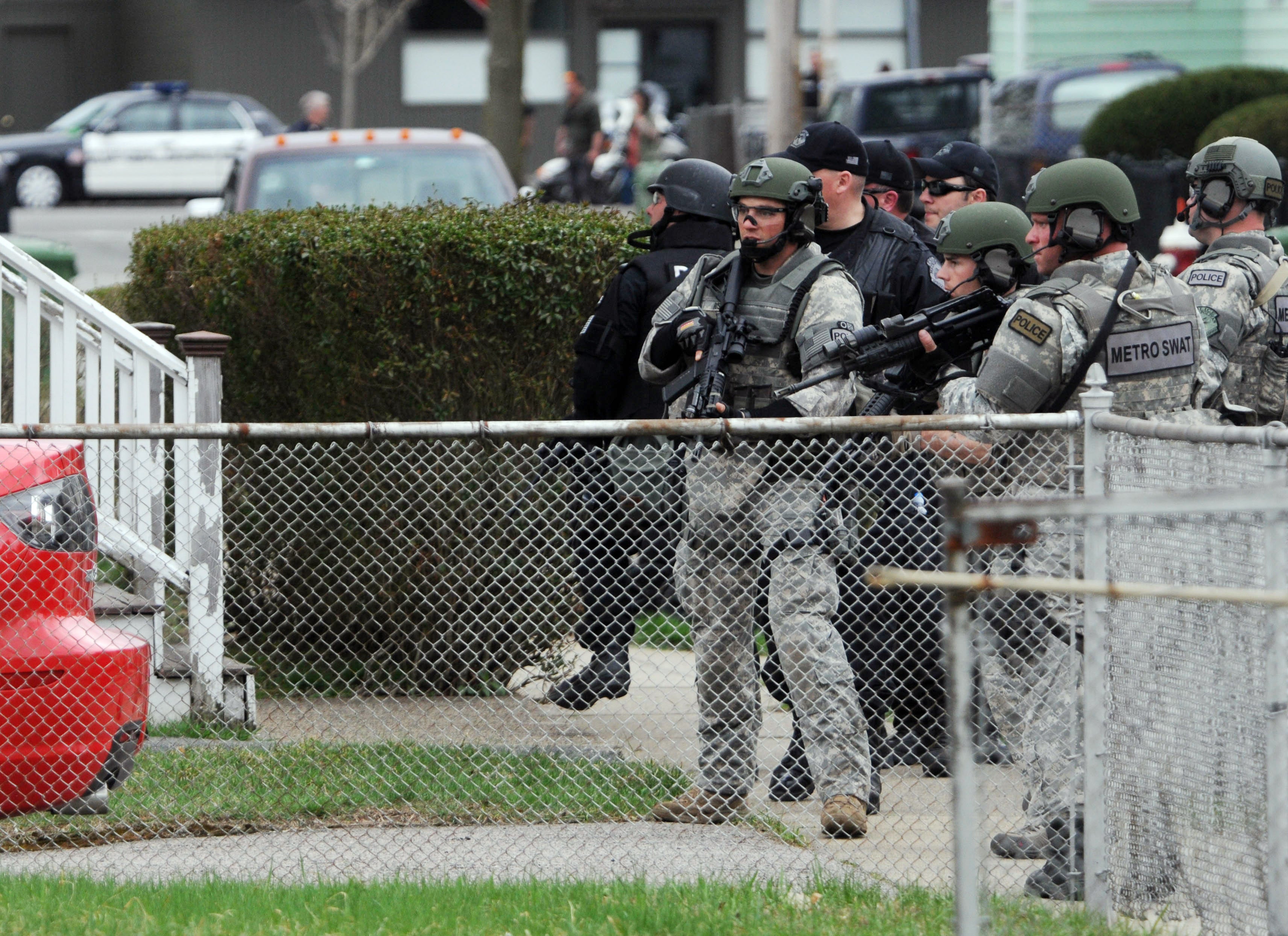 Police conduct a door-to-door search for suspect Dzhokhar Tsarnaev on 19 April 2013 in Watertown, Massachusetts