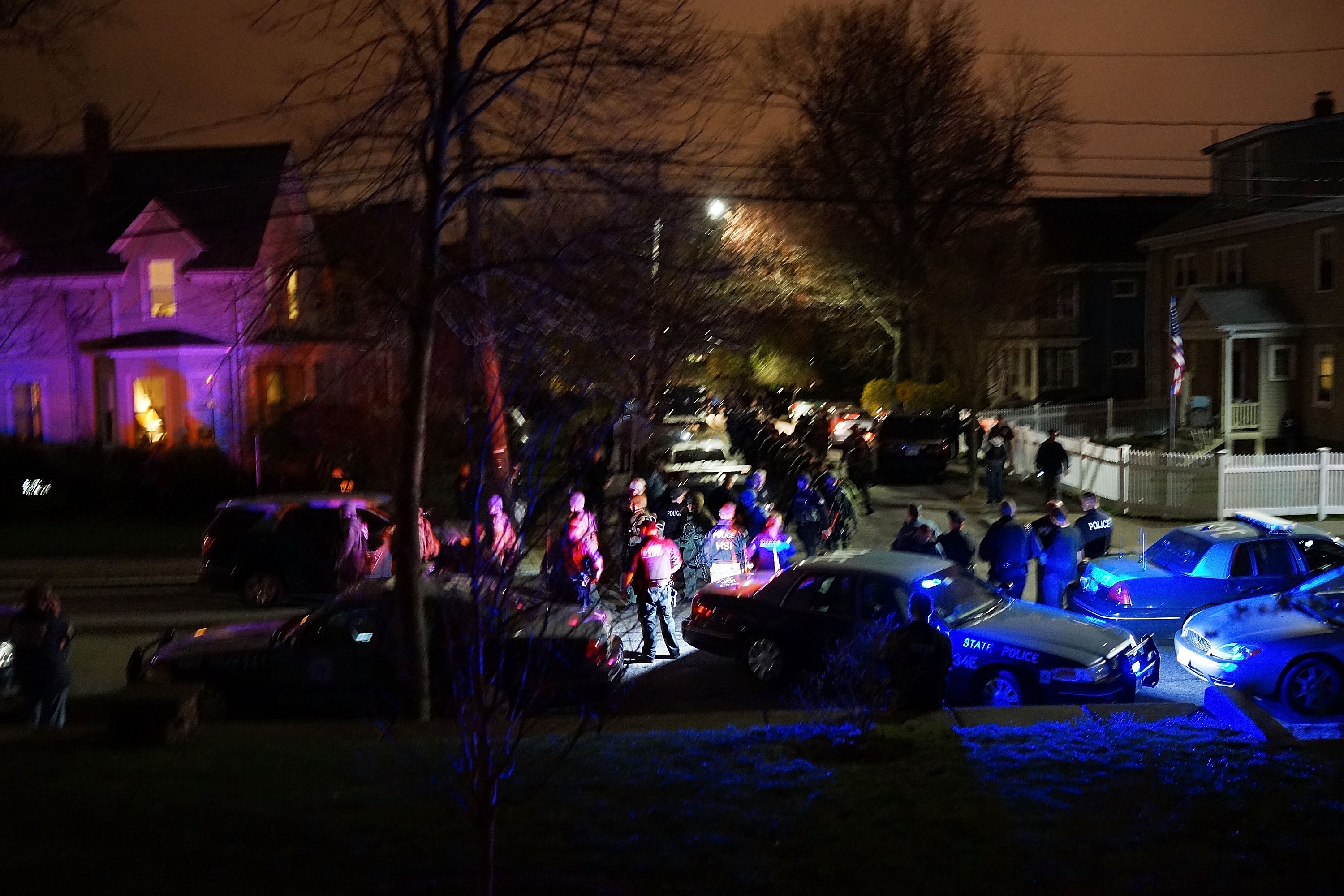 Members of a police SWAT team exit Franklin Street moments after suspect Dzhokhar Tsarnaev was apprehended on 19 April 2013 in Watertown, Massachusetts