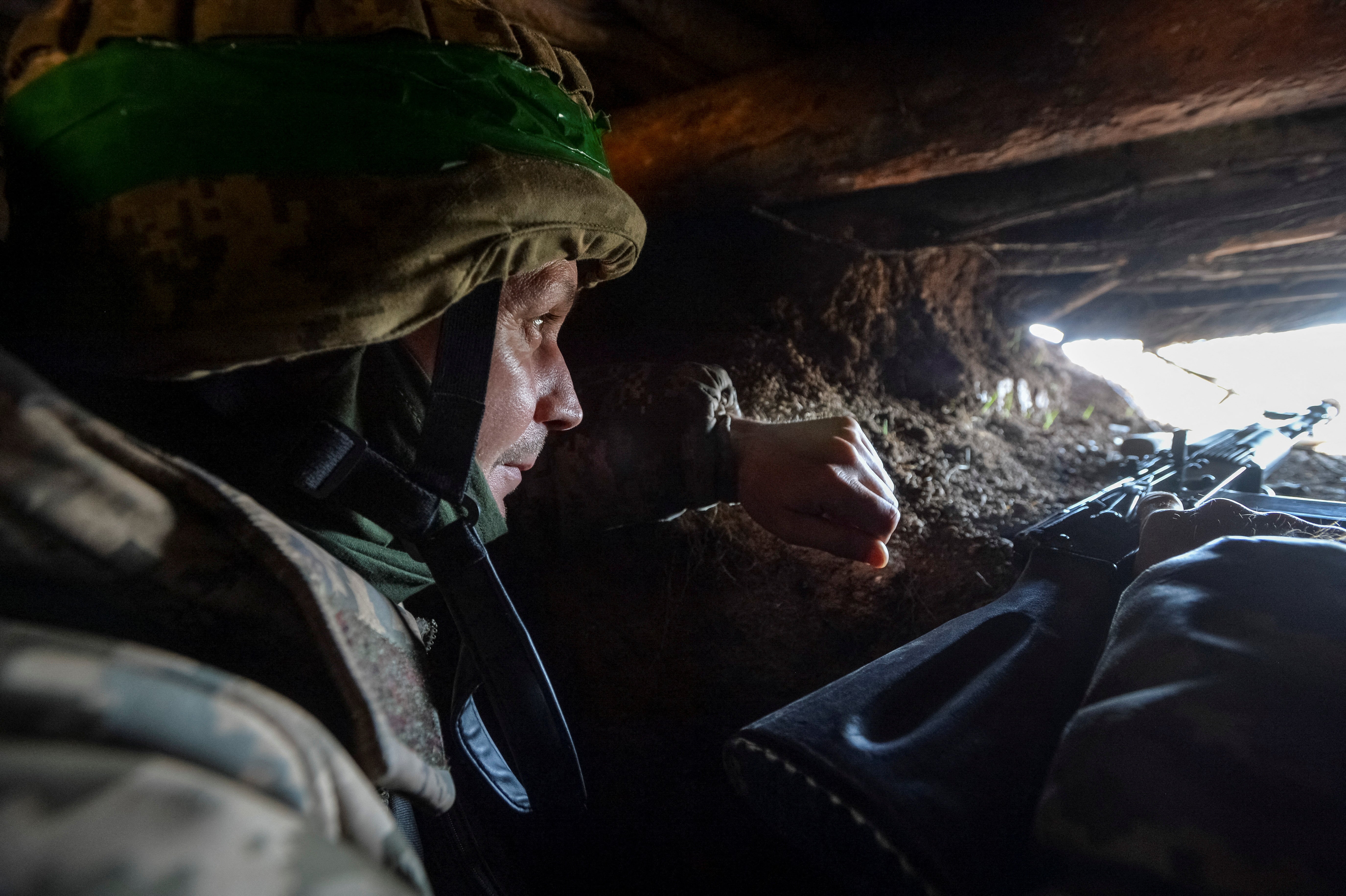 A Ukrainian service member is seen in a trench at a position on a front line, as Russia’s attack on Ukraine continues, near the city of Bakhmut, Ukraine 10 April 2023