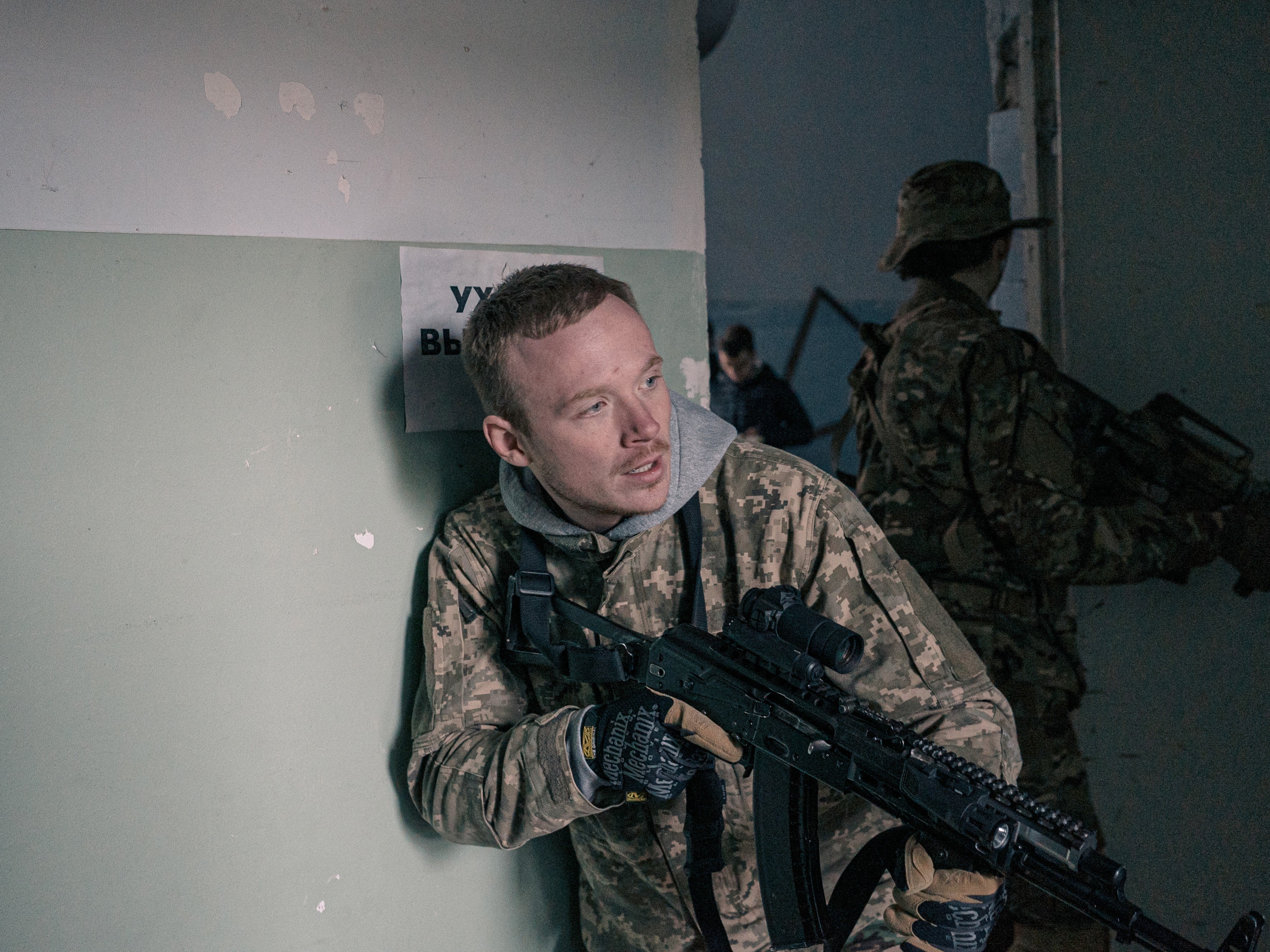 A young man takes part in a private training session led by a Ukrainian active-duty serviceman in a warehouse in Kyiv