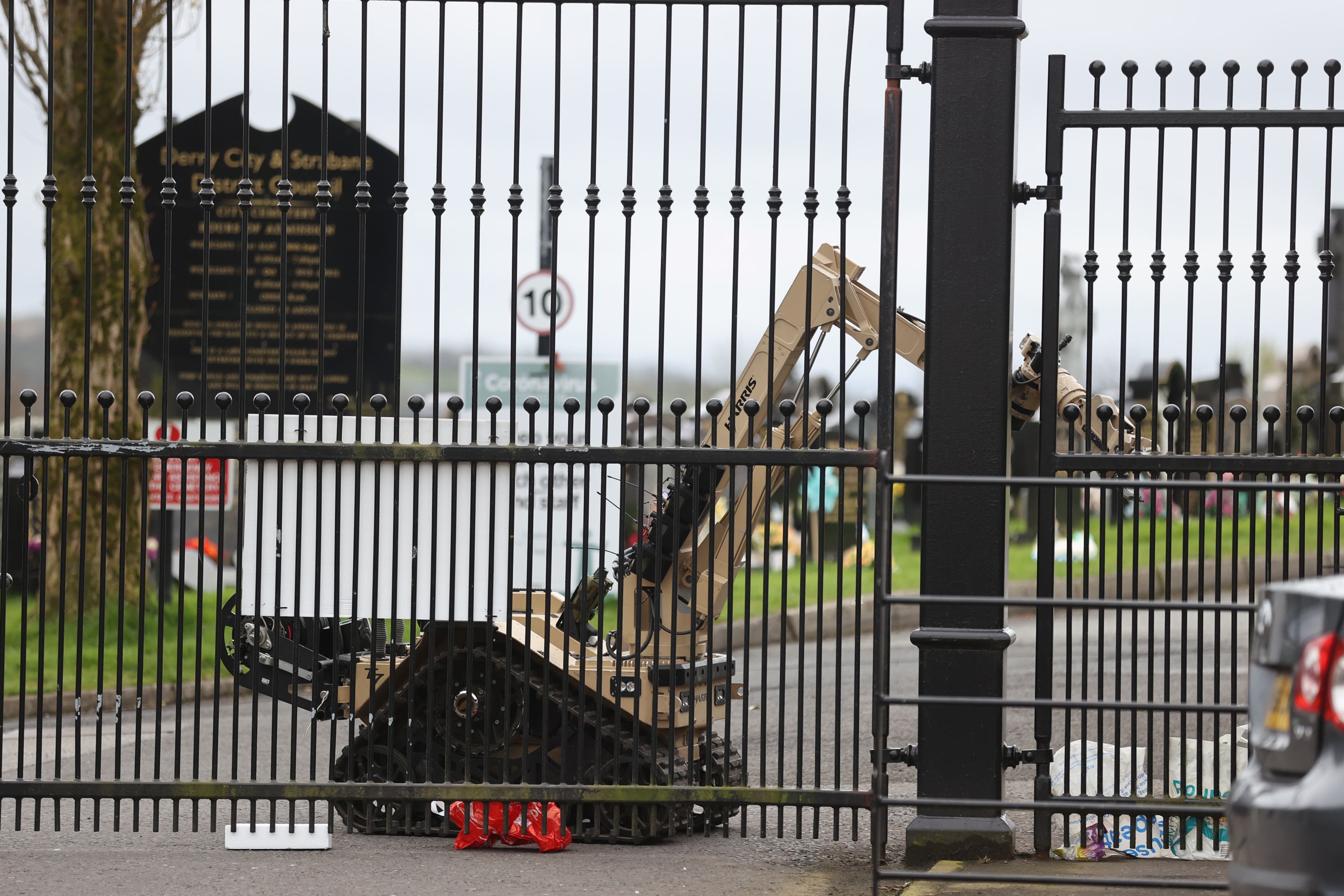 Ammunition Technical Officers operate a remote bomb disposal robot to check for devices at Derry City Cemetery, following a dissident Republican parade in the Creggan area of Londonderry on Easter Monday (Liam McBurney/PA)