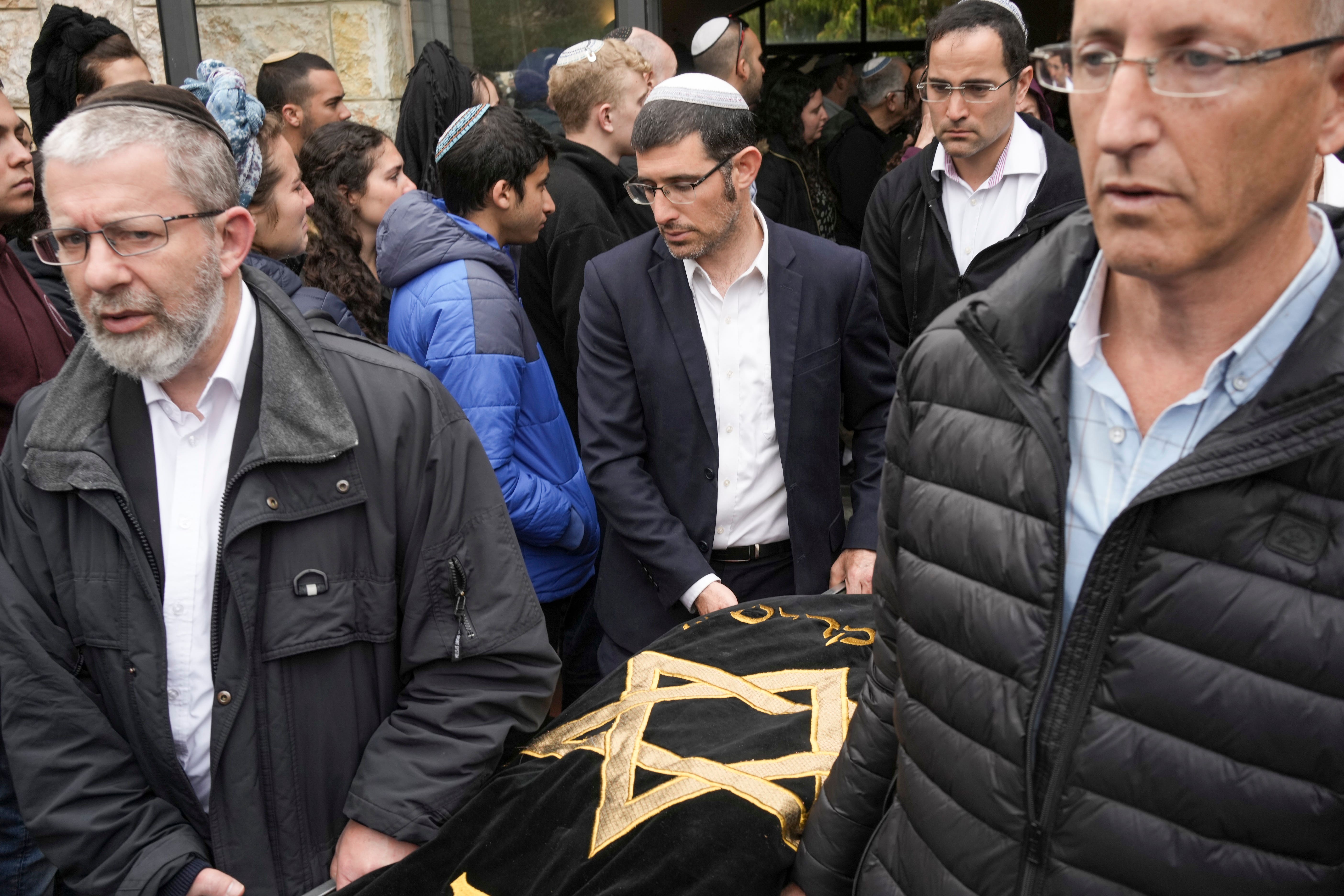 Mourners carry the body of Lucy Dee (Maya Alleruzzo/AP)