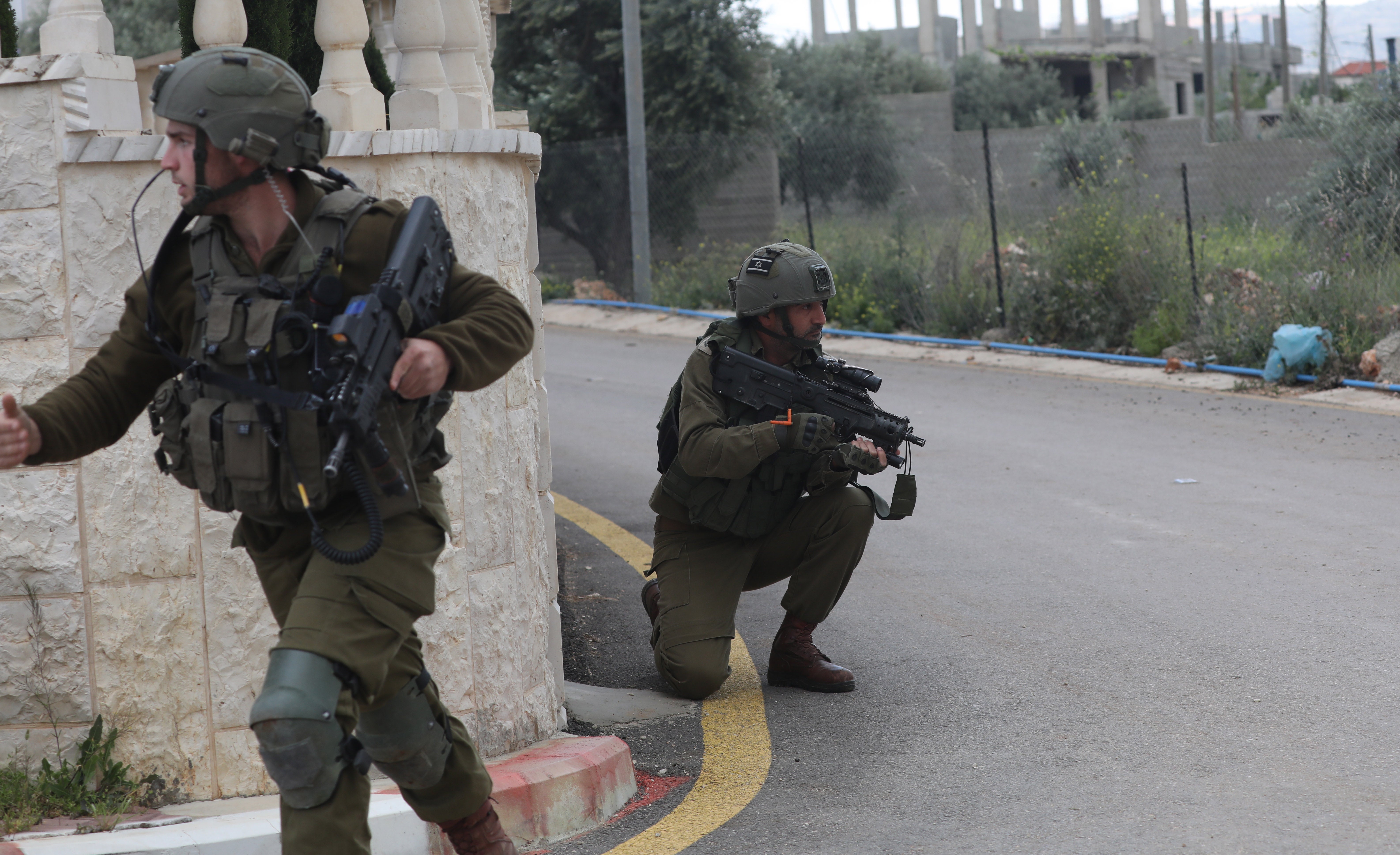 Israeli soldiers take position in the area where two Palestinian militants were killed, near the settlement of Elon Moreh near the west bank city of Nablus