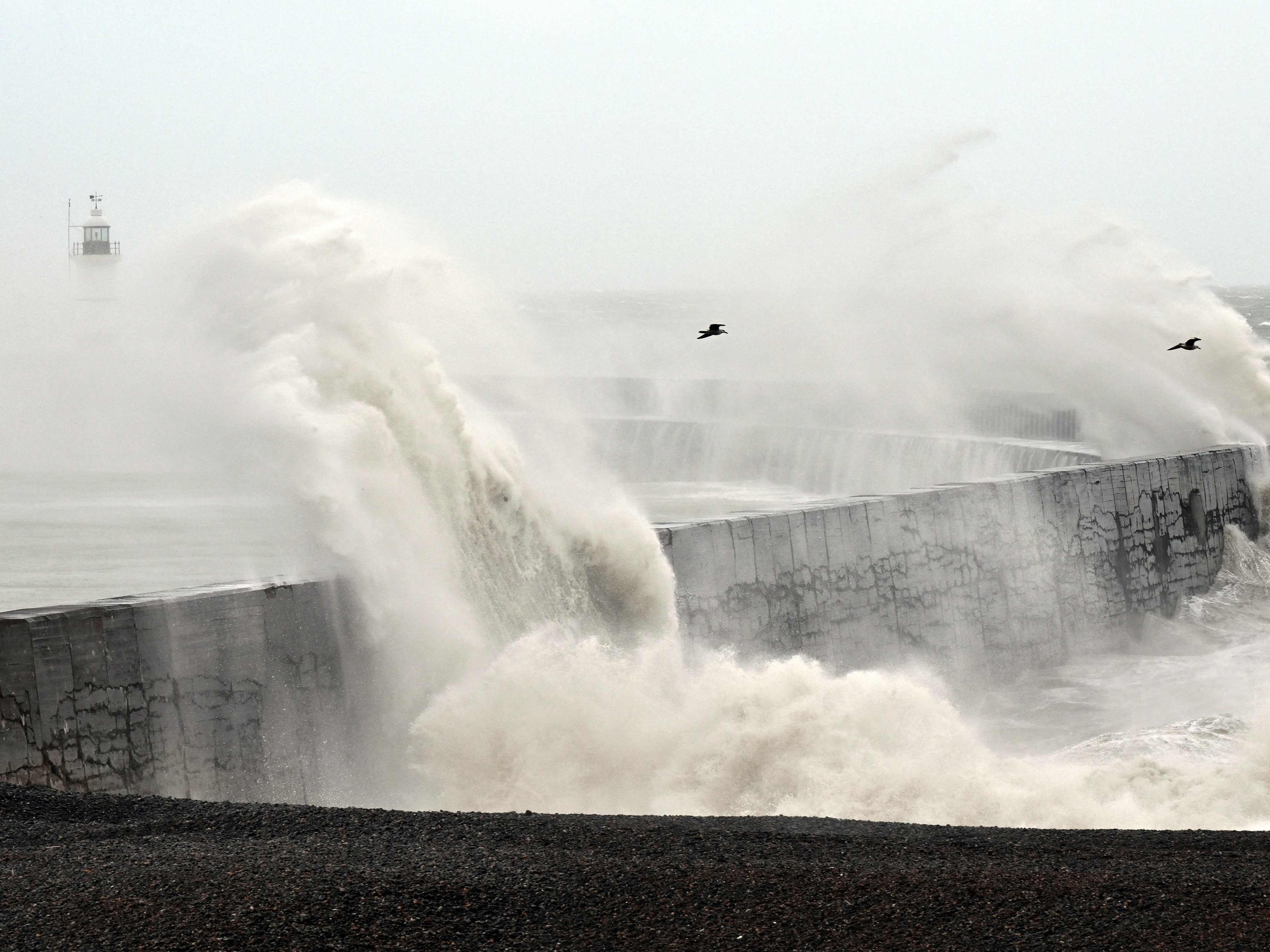 Waves break over Newhaven Lighthouse