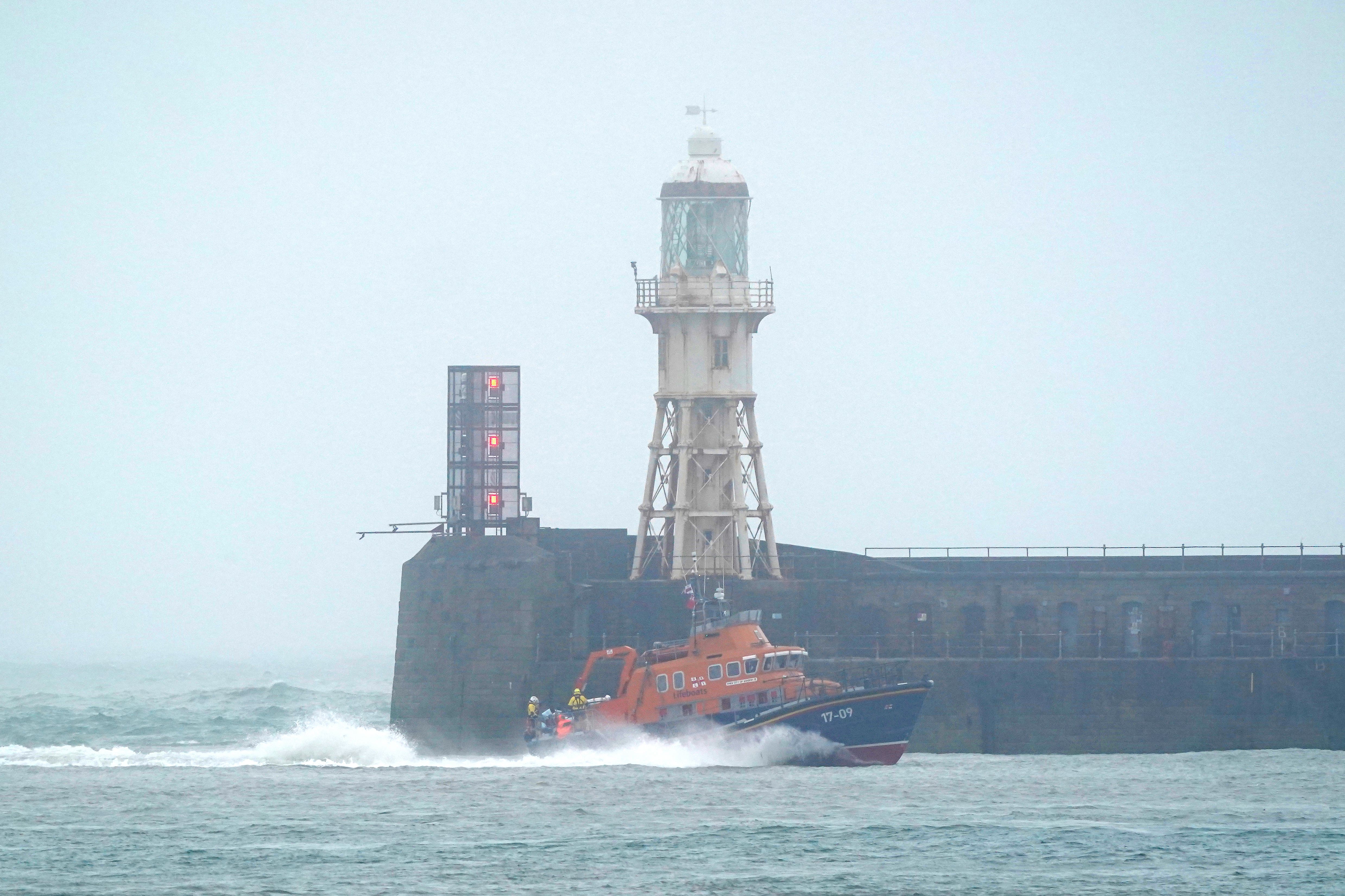 A group of people thought to be migrants are brought in to Dover, Kent, onboard the RNLI Dover Lifeboat following a small boat incident in the Channel (Gareth Fuller/PA)