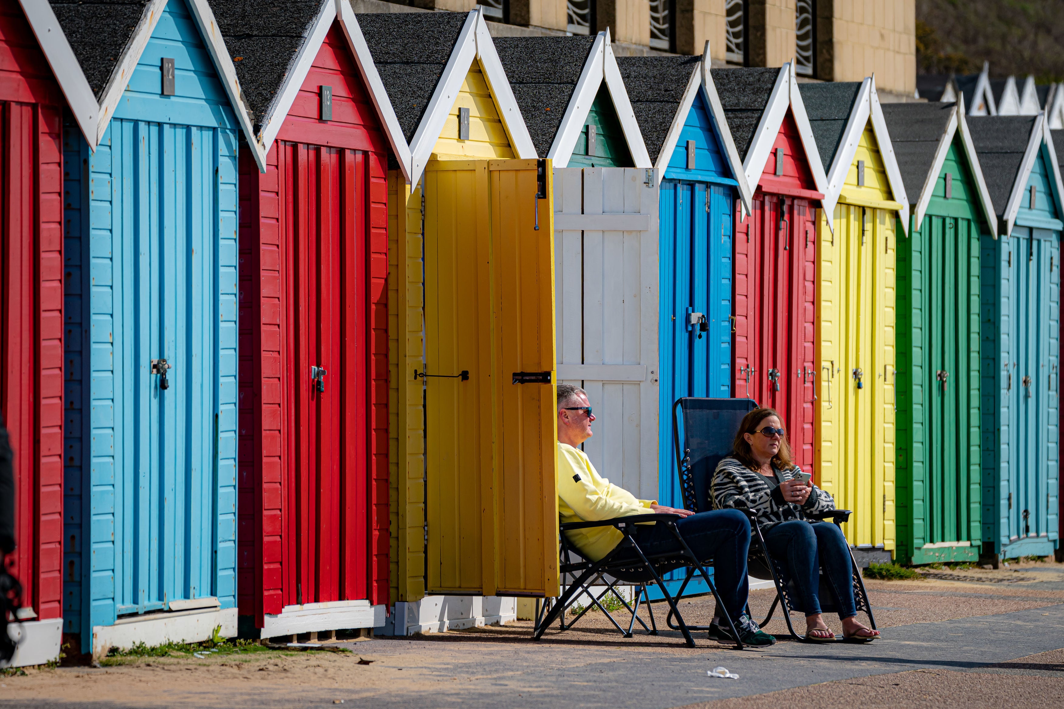 People on the promenade enjoying the warm weather on Bournemouth beach over the Easter Bank Holiday weekend