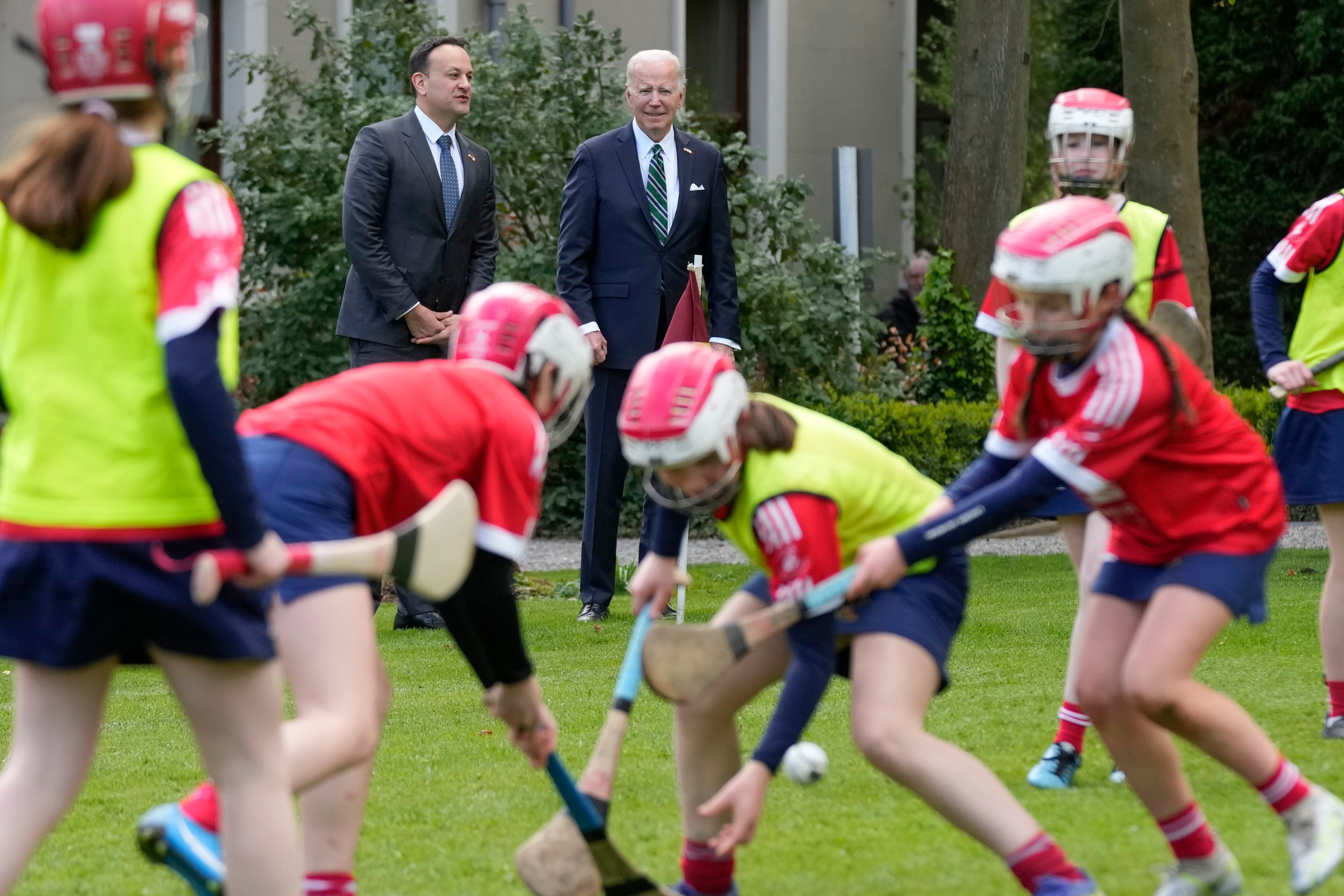 Ireland’s prime minister Leo Varadkar watches with Biden as girls play hurling during a youth Gaelic sports demonstration in Dublin on Thursday