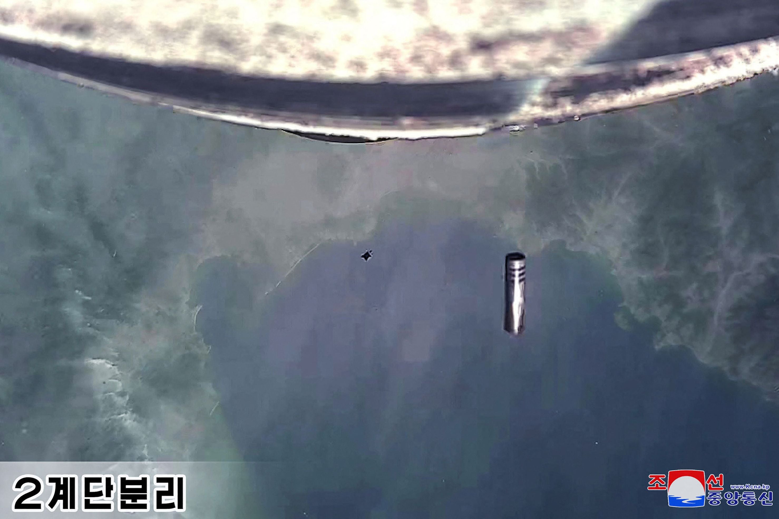 North Korea’s new solid-fuel intercontinental ballistic missile during second stage separation scene taken by a camera mounted on the new Hwasong-18 intercontinental ballistic missile (ICBM)