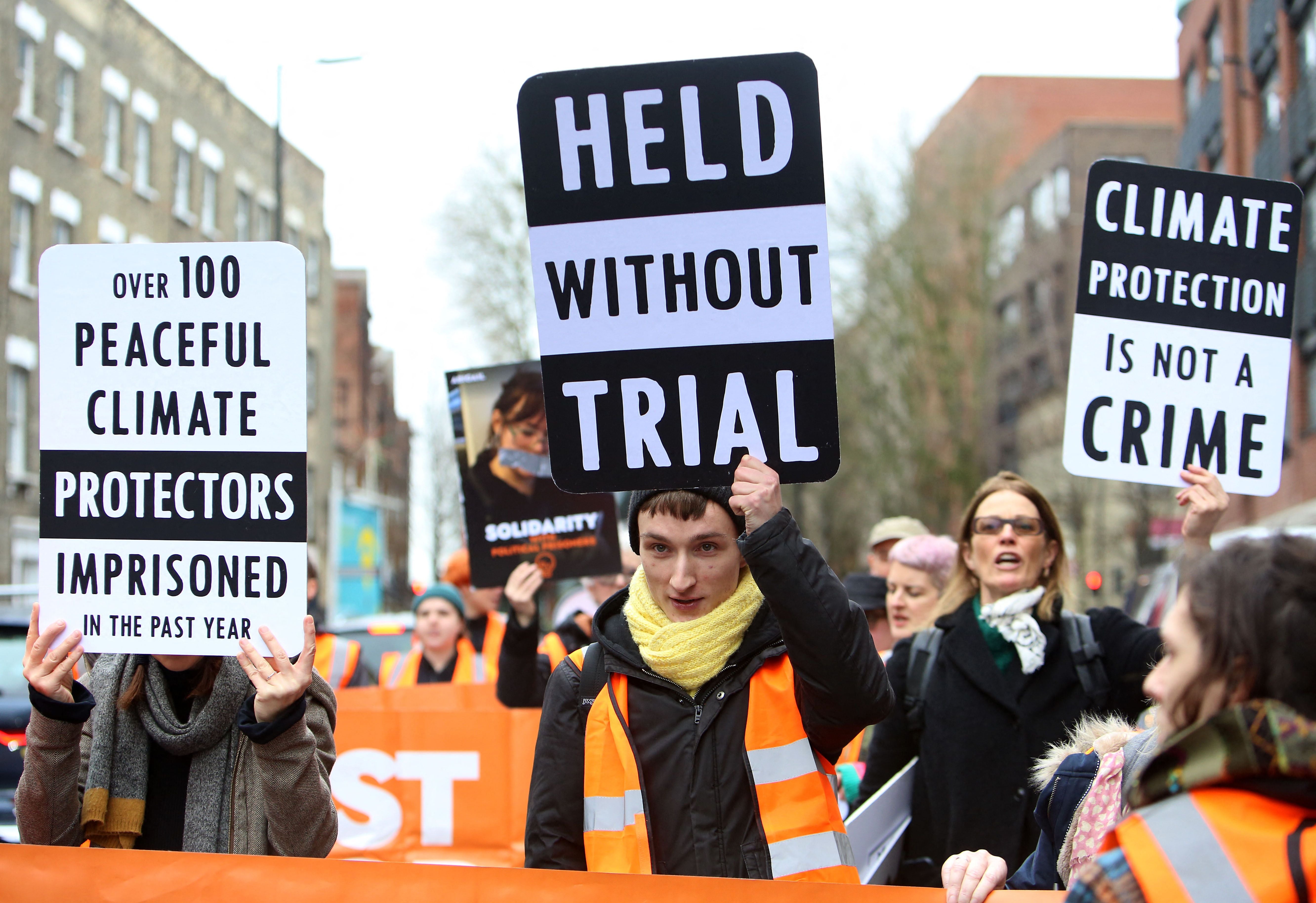 Activists from the Just Stop Oil climate change campaign group hold up placards as they march from Pentonville Prison in protest at the holding of political prisoners