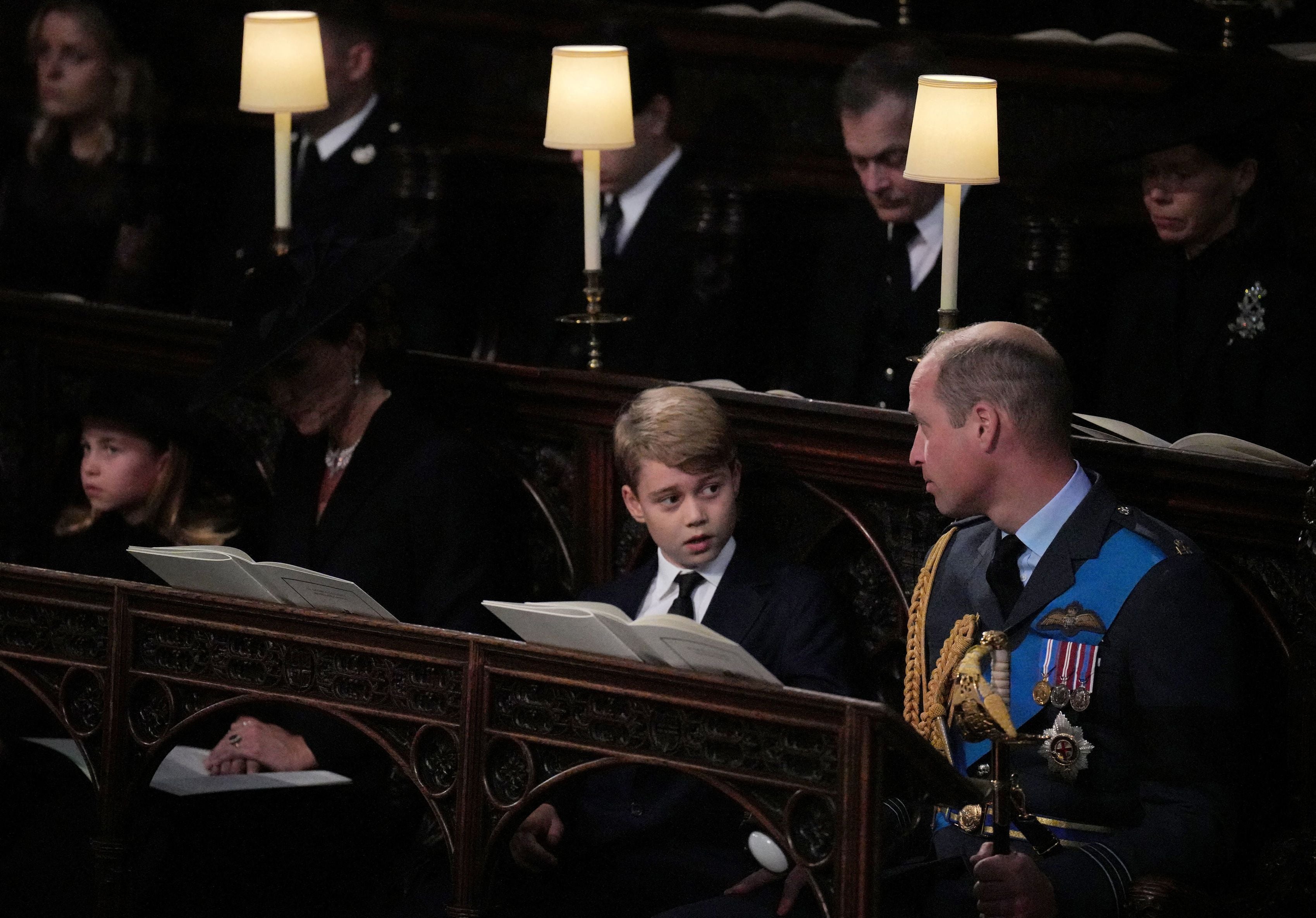 Prince George (centre) speaks with his father, William, Prince of Wales