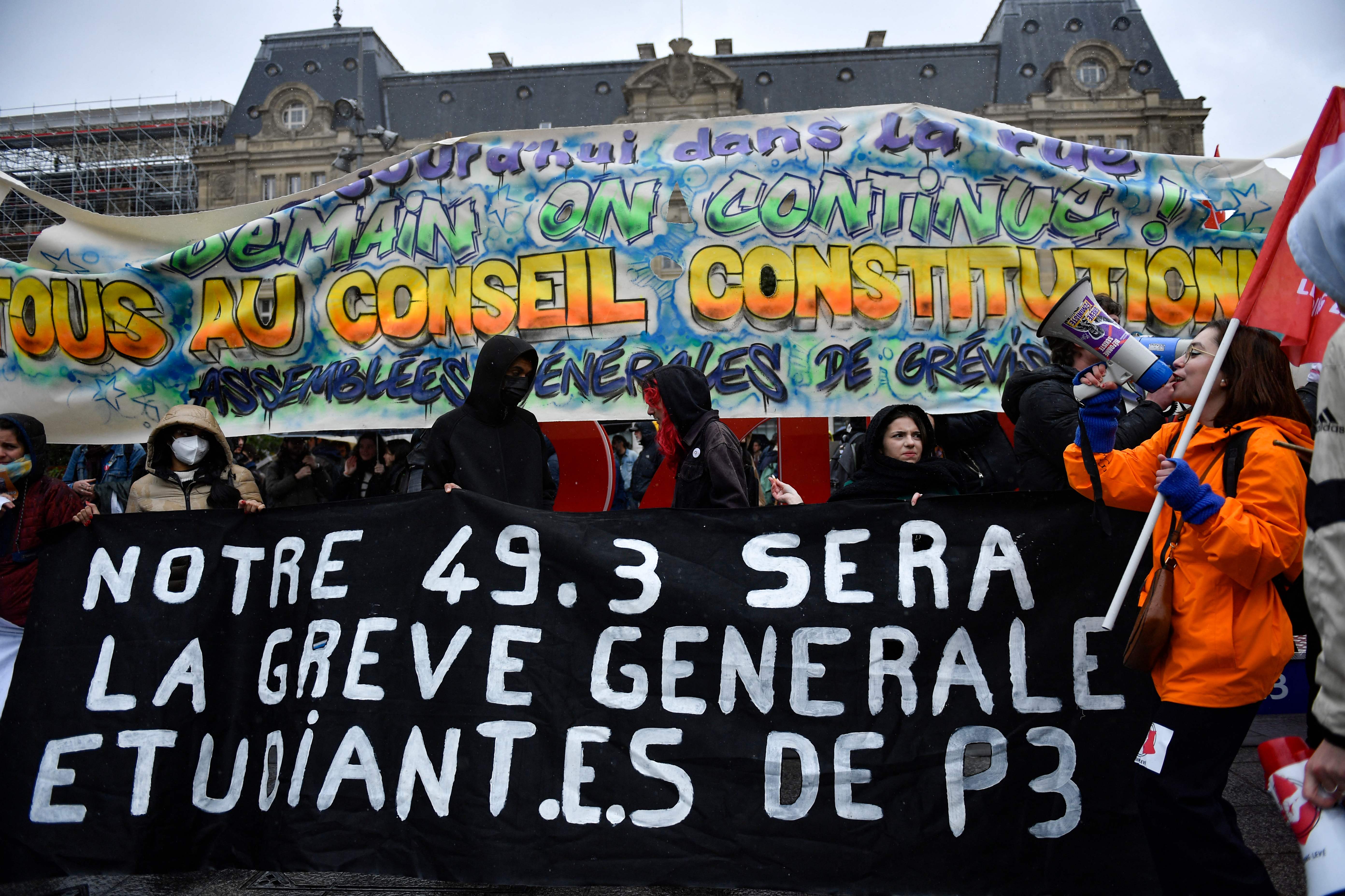 Students and young protesters march towards the Constitutional Council building