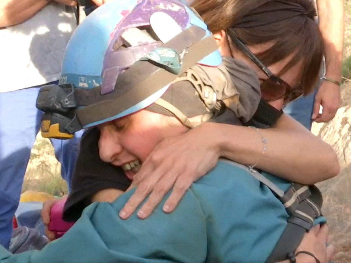 Beatriz Flamini hugs teammates as she is helped out of the cave