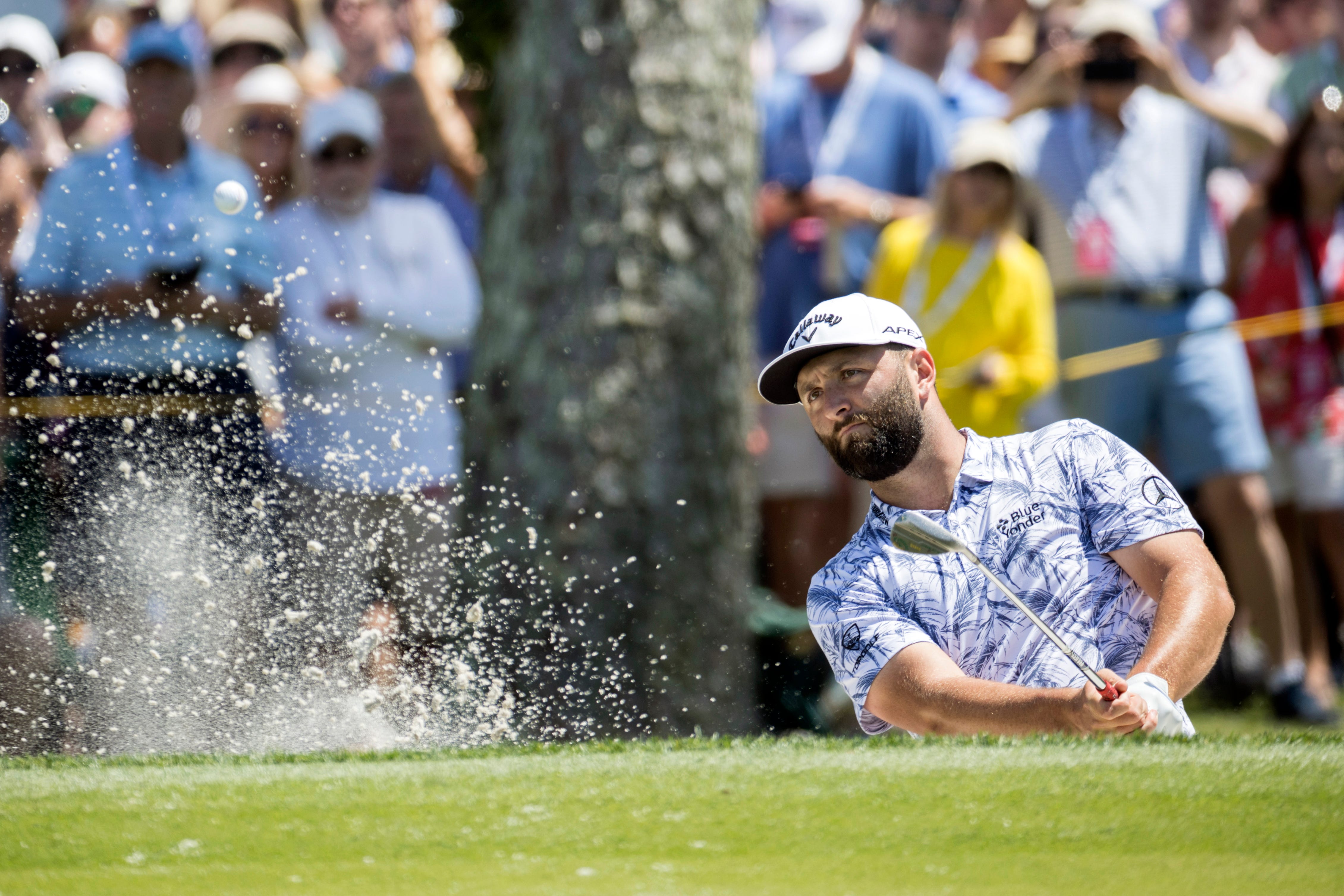 Jon Rahm hits out of a bunker (Stephen B Morton/AP)