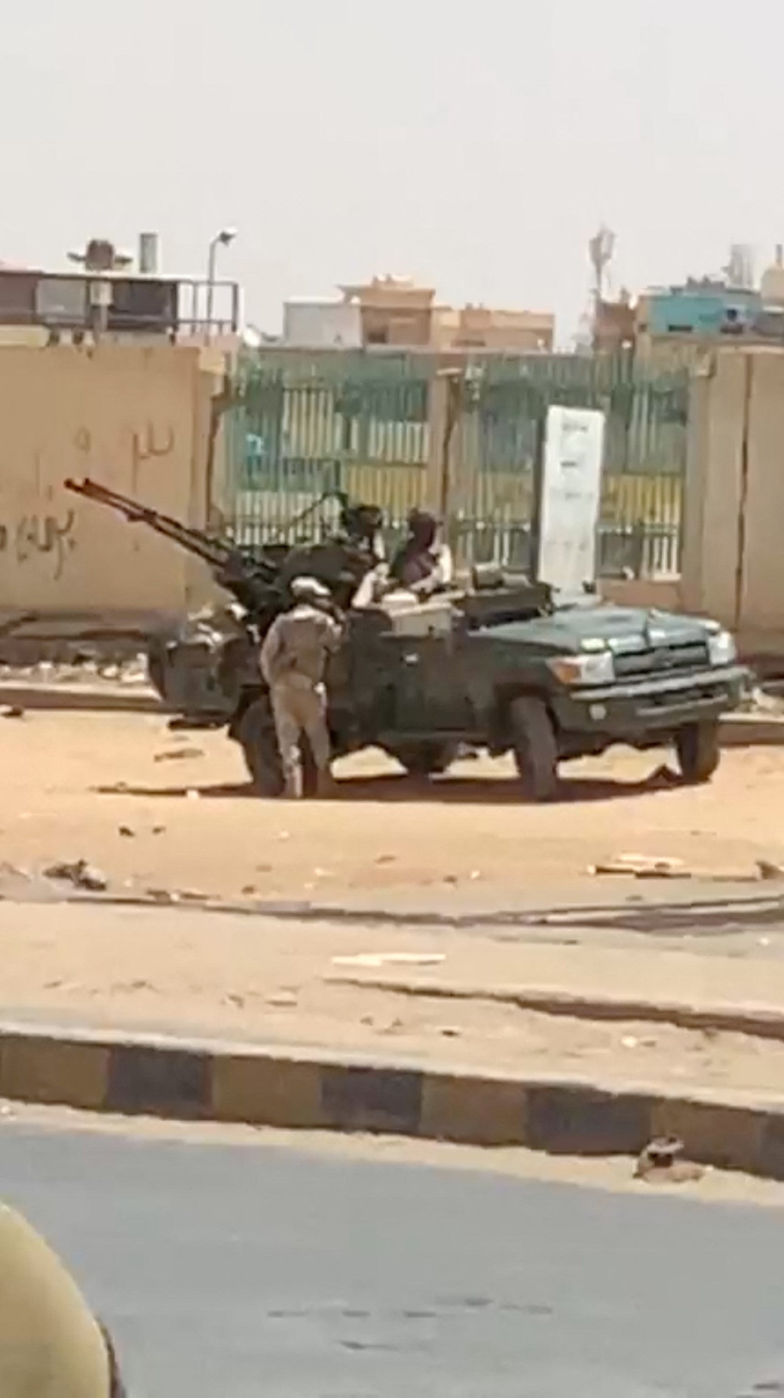 A military vehicle and soldiers are seen on a street of Khartoum