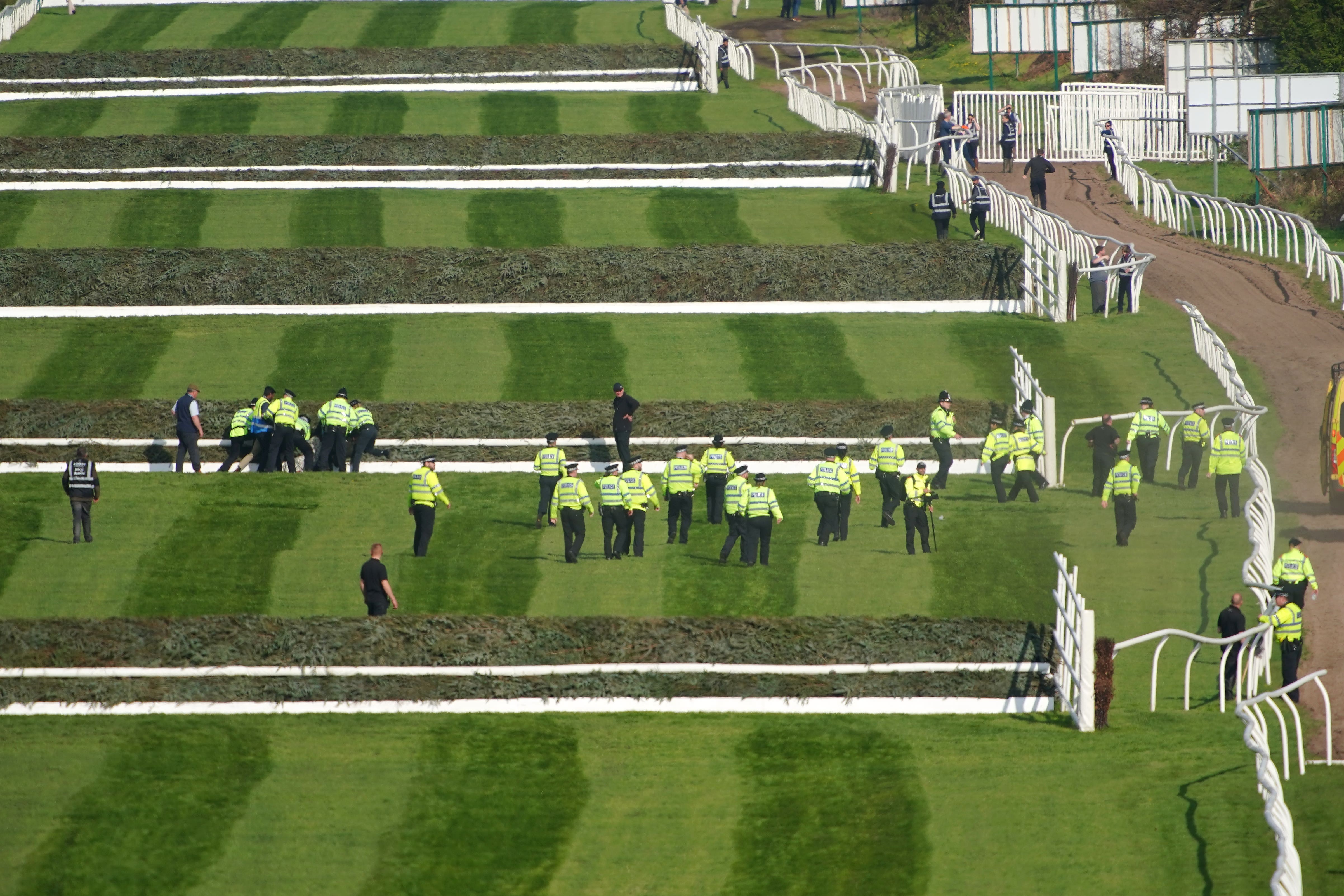 Police officers respond to Animal Rising activists (Peter Byrne/PA)