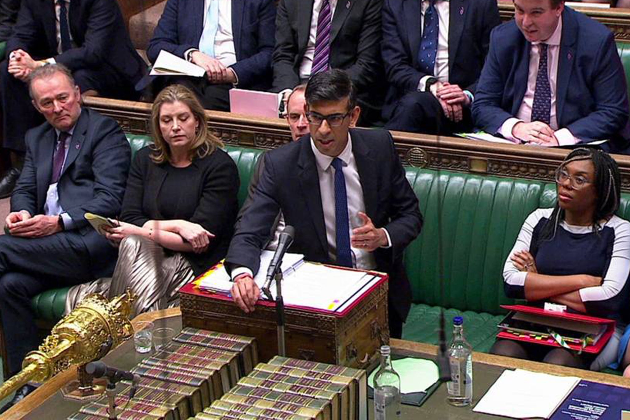 Simon Hart (left) watches Rishi Sunak in the Commons in April 2023