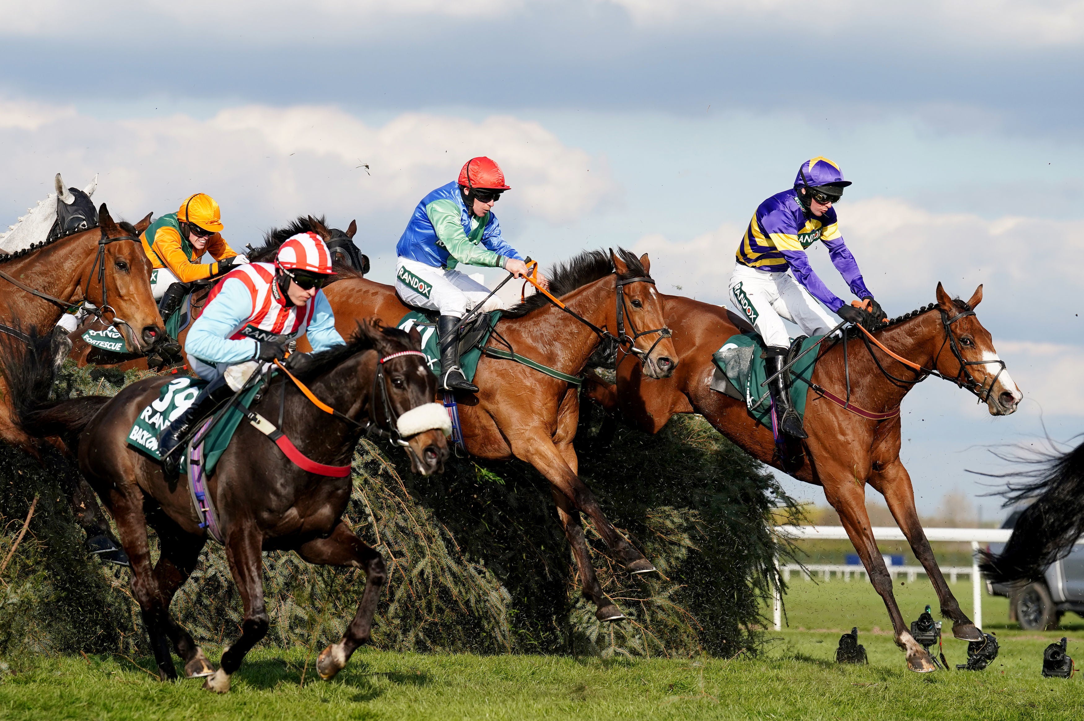 Corach Rambler ridden by Derek Fox (right) on their way to winning the Randox Grand National