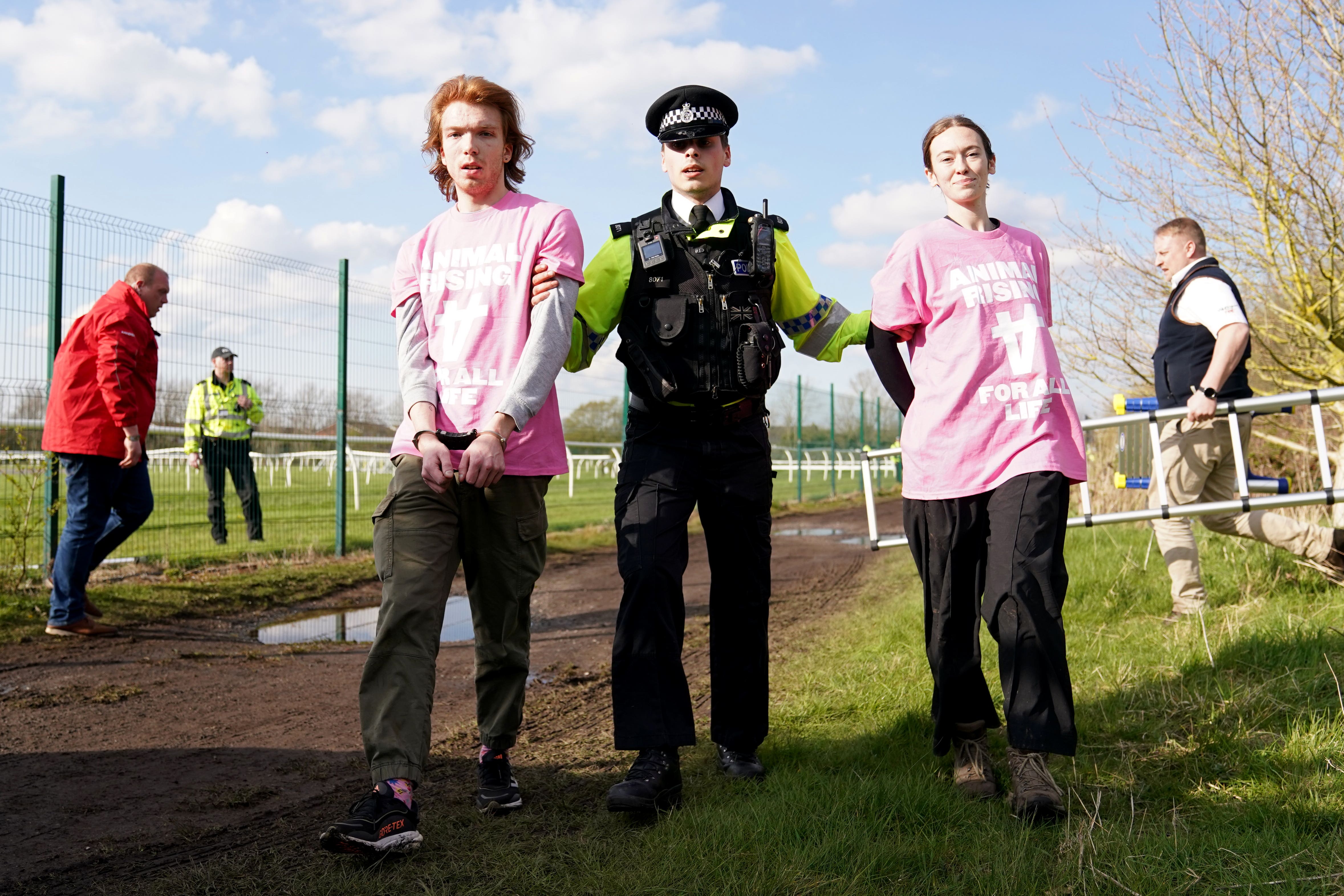 Protestors are removed by police at the Randox Grand National (Tim Goode/PA).