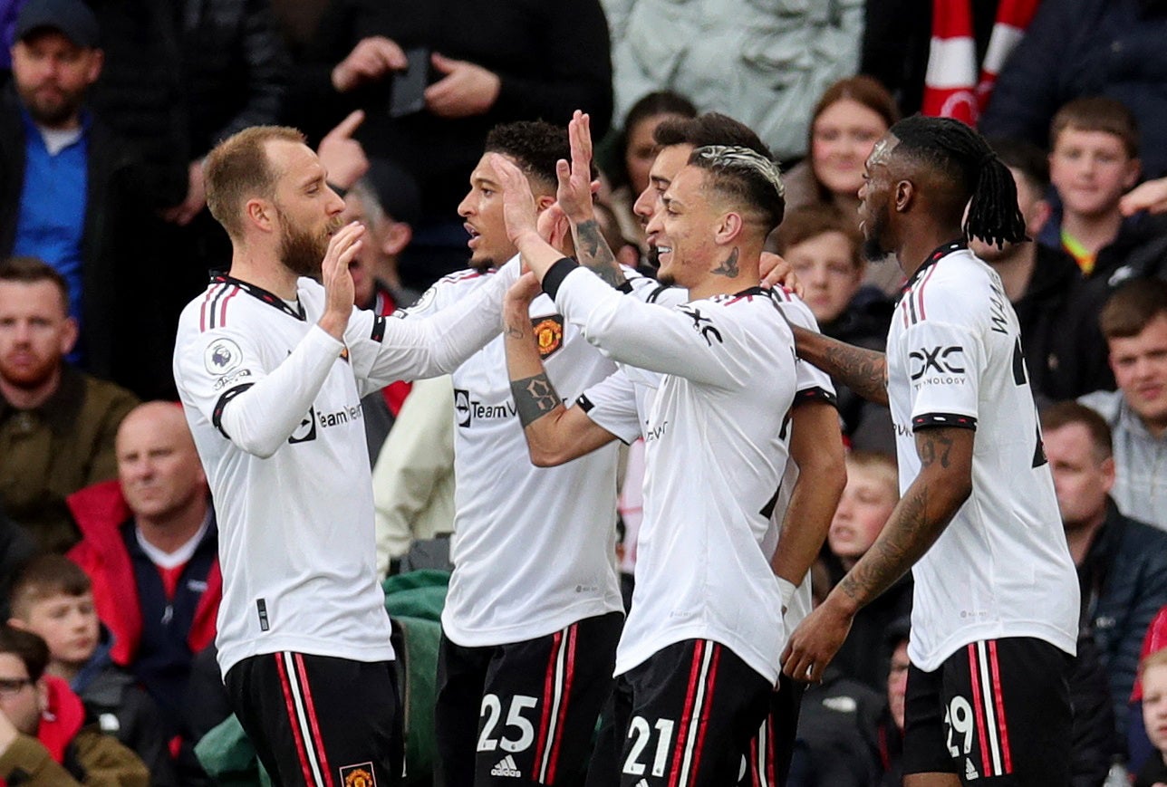 Christian Eriksen, left, celebrates with teammates after United score