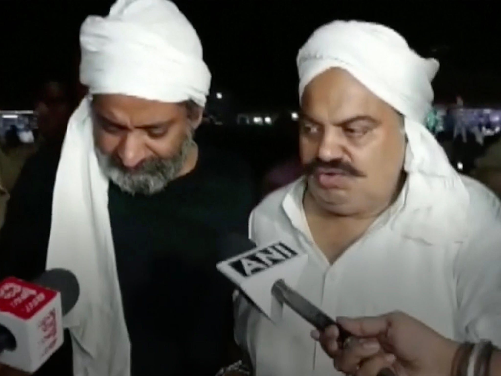 Ashraf Ahmed (left) and Atiq Ahmed moments before being murdered on live TV