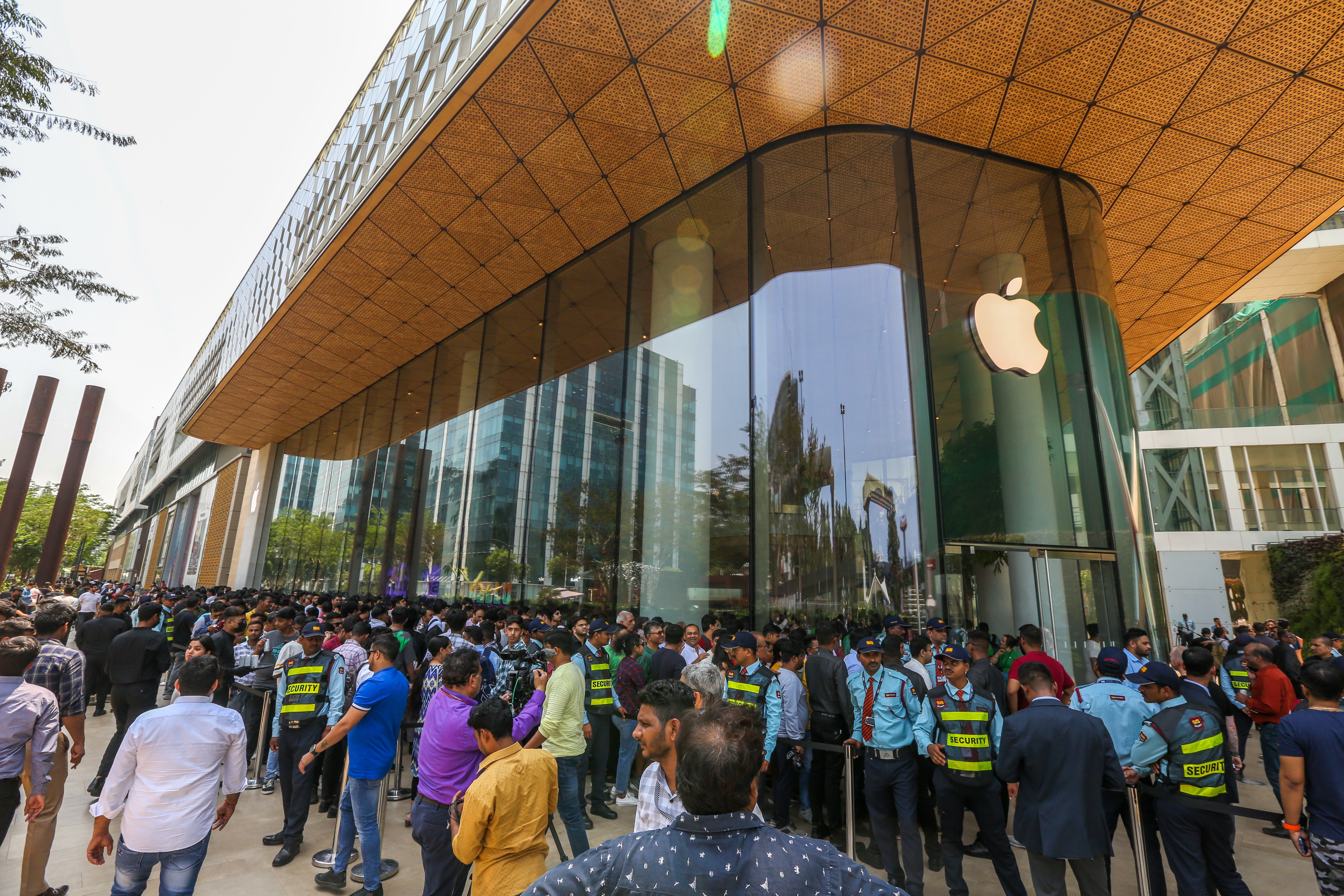 File: People queue outside the Apple retail store on the day of its launch in Mumbai, India