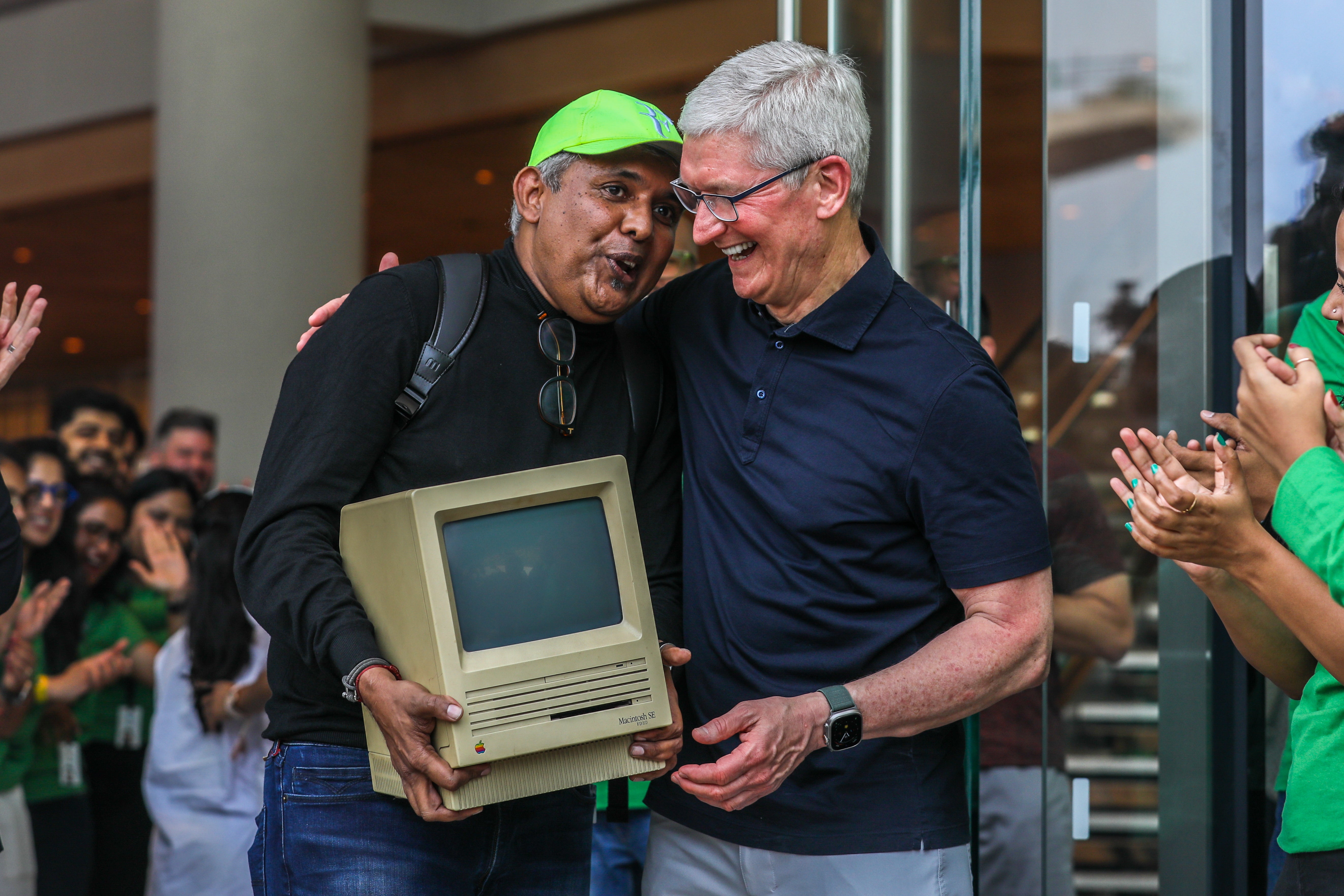 Apple’s chief executive officer Tim Cook welcomes consumers at the opening of the first Apple shop in Mumbai