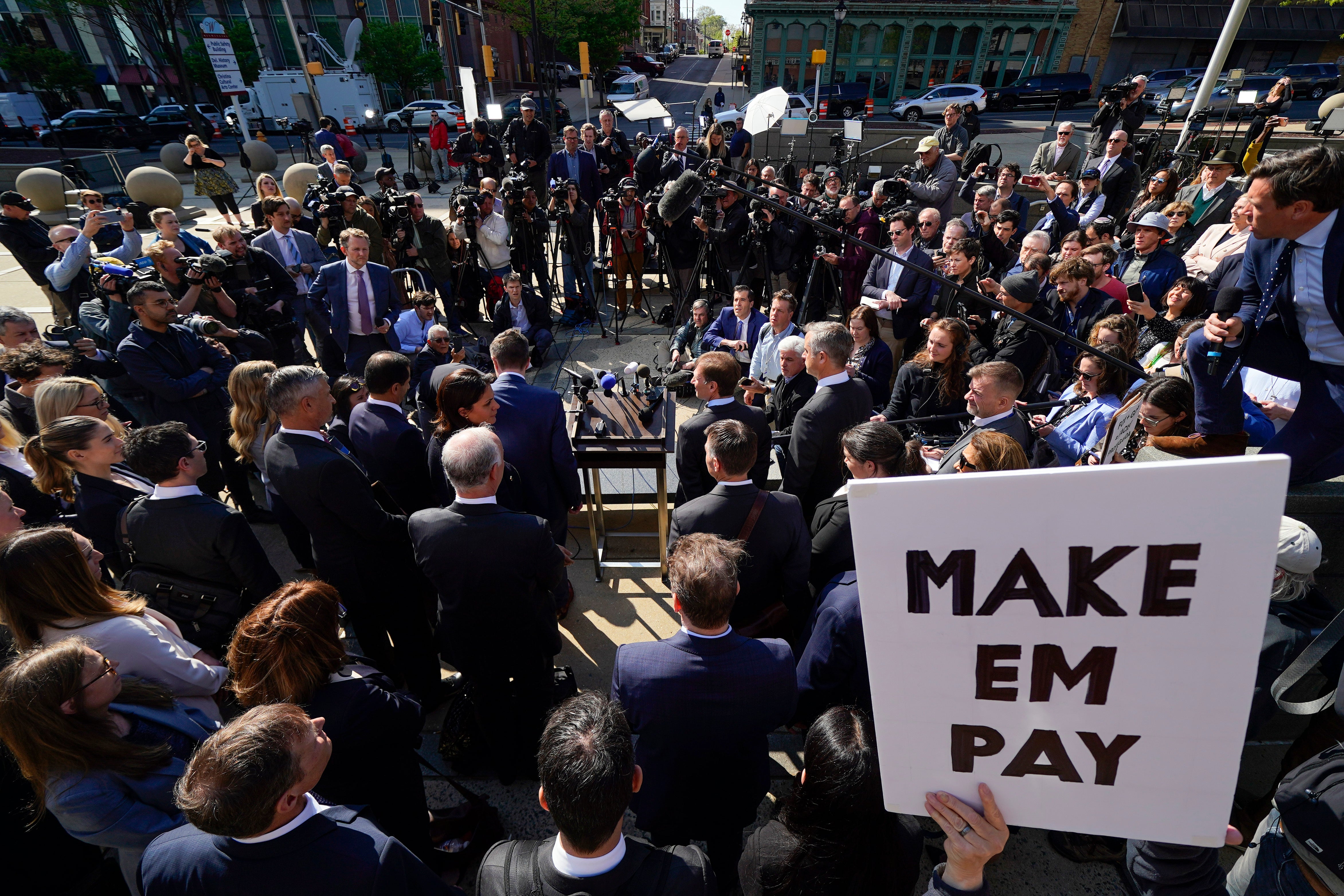 Attorneys for Dominion Voting Systems speak at a news conference outside New Castle County Courthouse in Wilmington, Del., after the defamation lawsuit by Dominion Voting Systems against Fox News was settled just as the jury trial was set to begin, Tuesday, April 18, 2023. (AP Photo/Julio Cortez)