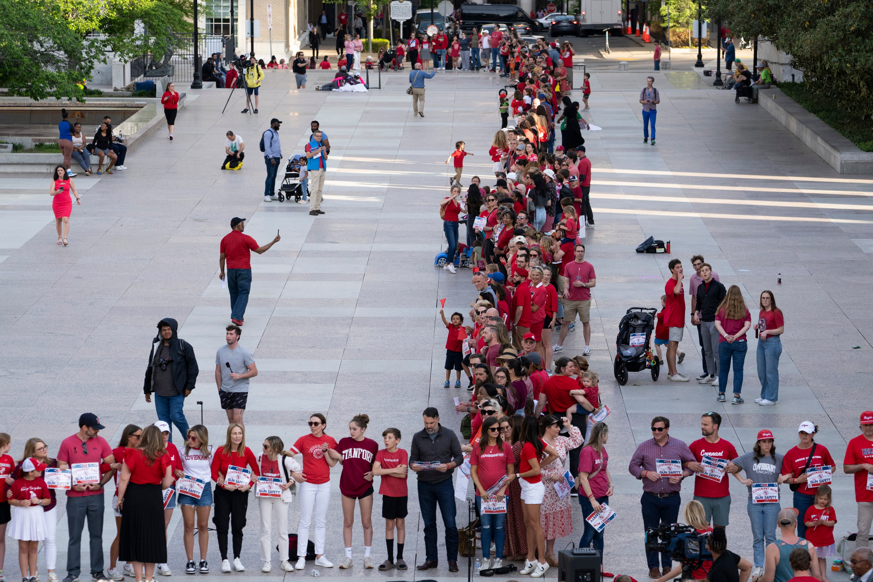 Demonstrators lock arms with each other during the “Arms Are for Hugging” protest for gun control legislation