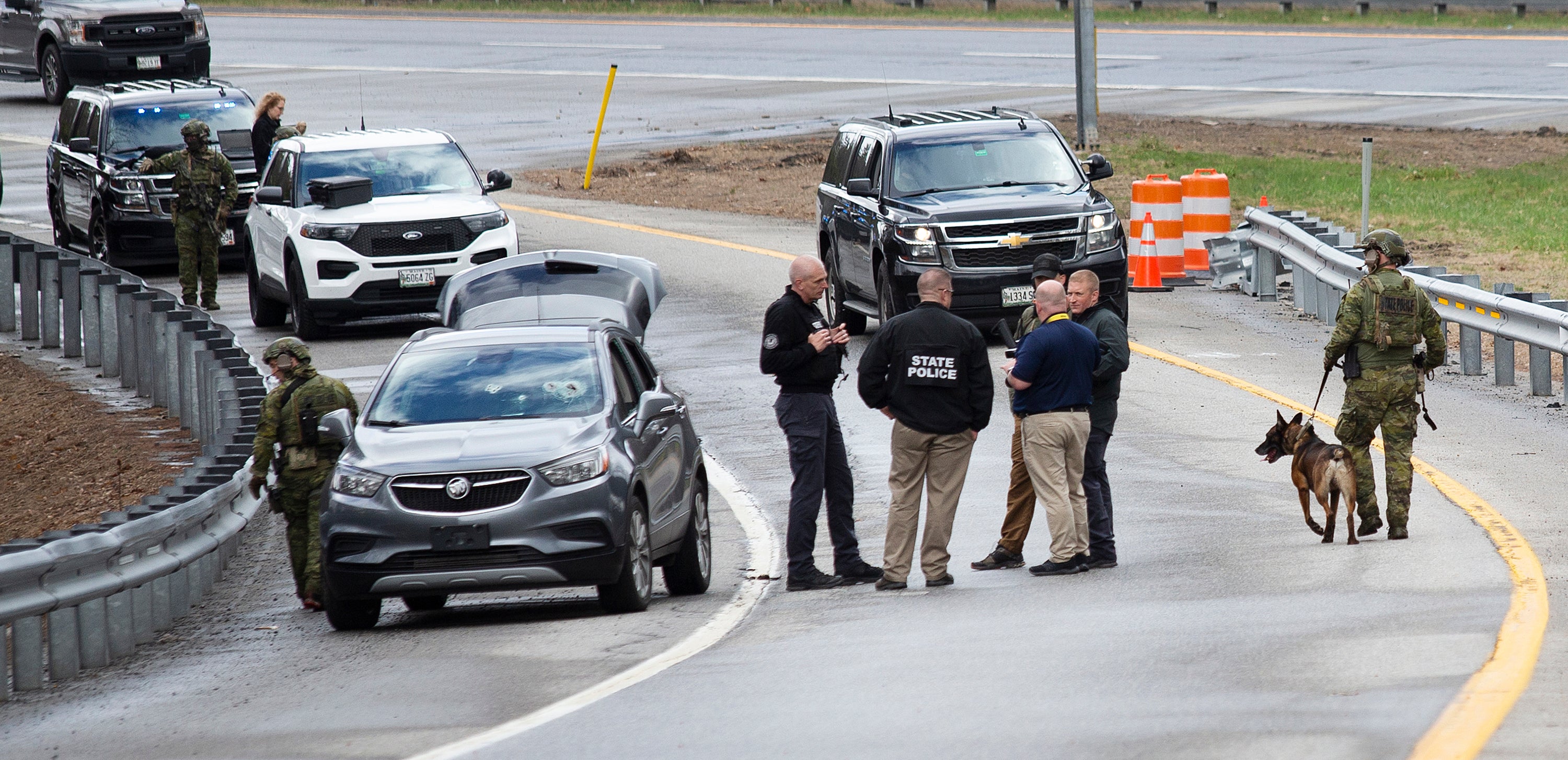 Members of law enforcement investigate a scene where people were injured in a shooting on Interstate 295, in Yarmouth, Maine, Tuesday, April 18, 2023