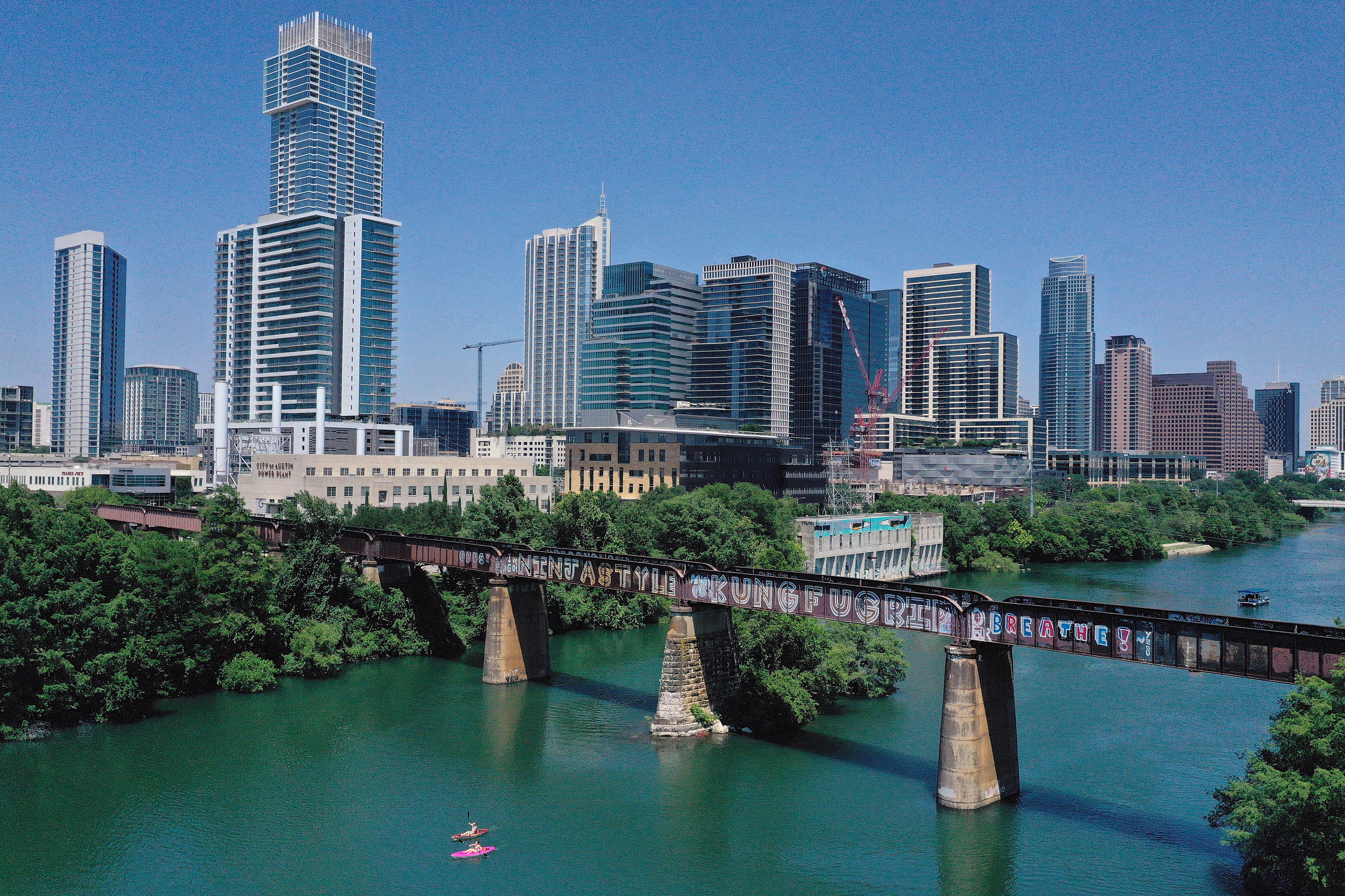 In this aerial view from a drone, residents paddle board and kayak in Lady Bird Lake on May 20, 2020 in Austin, Texas