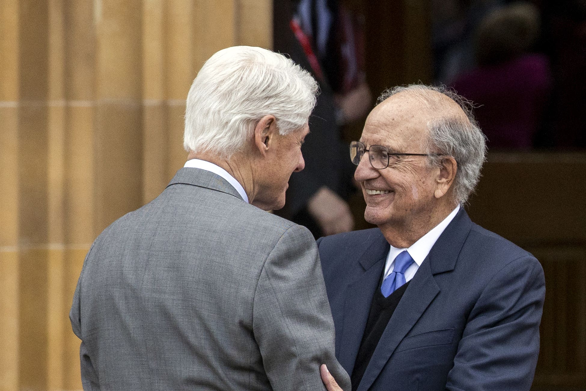 Former US president Bill Clinton greets former US senator George Mitchell (Liam McBurney/PA)