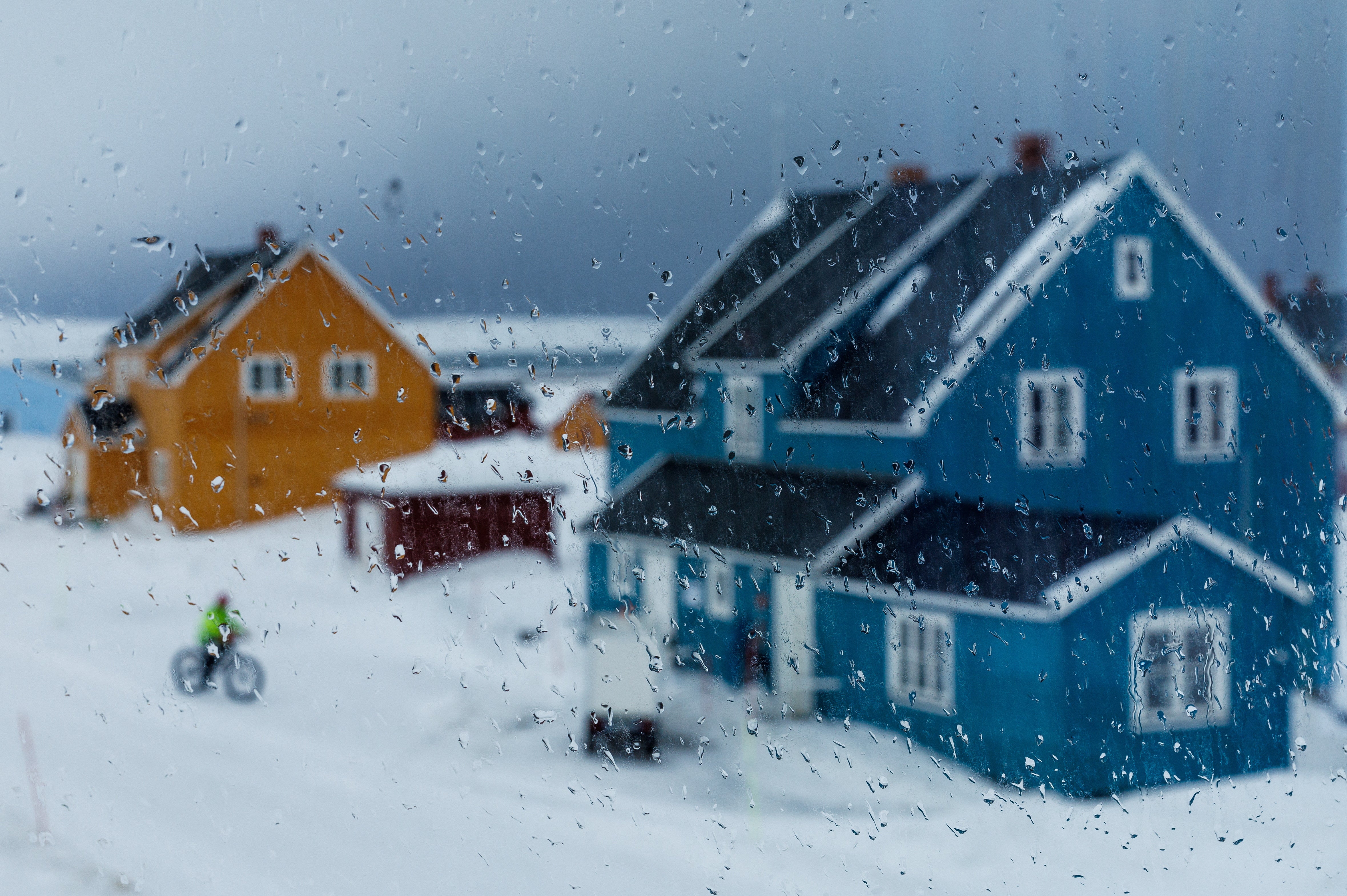 Raindrops are seen on a window as rain approaches Ny-Alesund