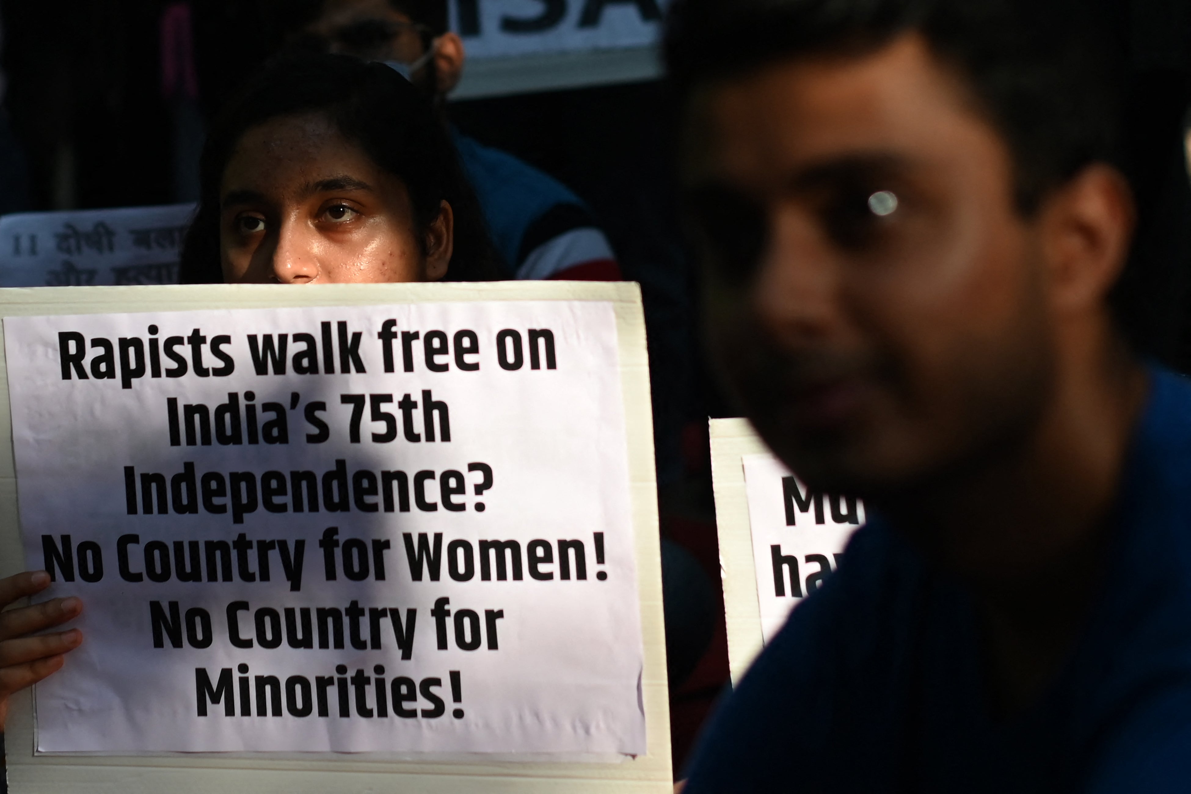 Demonstrators hold placards during a protest against the release of men convicted of gang-raping of Bilkis Bano during the 2002 communal riots in Gujarat, in New Delhi on 27 August 2022