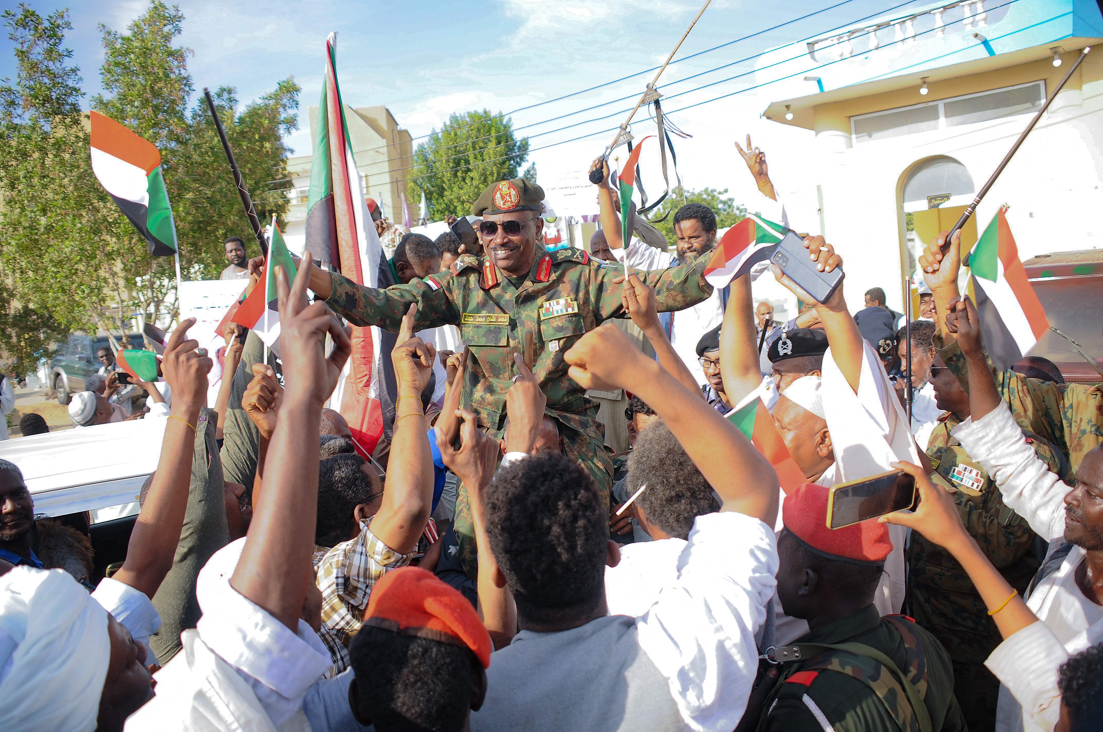 People carry on their shoulders Othman Mohamed, a senior general loyal to army chief Abdel Fattah al-Burhan