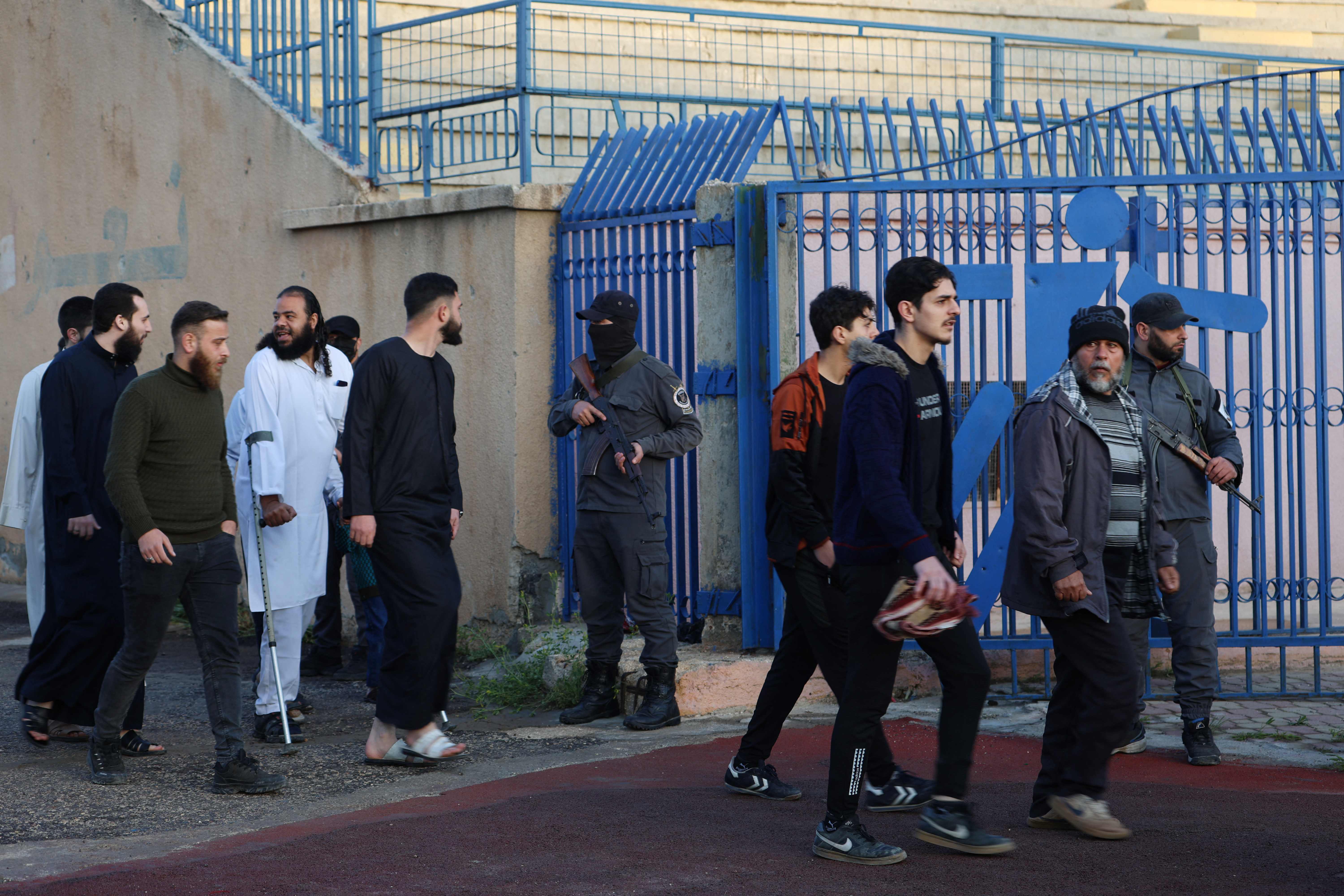 Muslim worshippers enter the secured municipal stadium in Syria’s rebel-held northwestern city of Idlib to attend the morning prayers