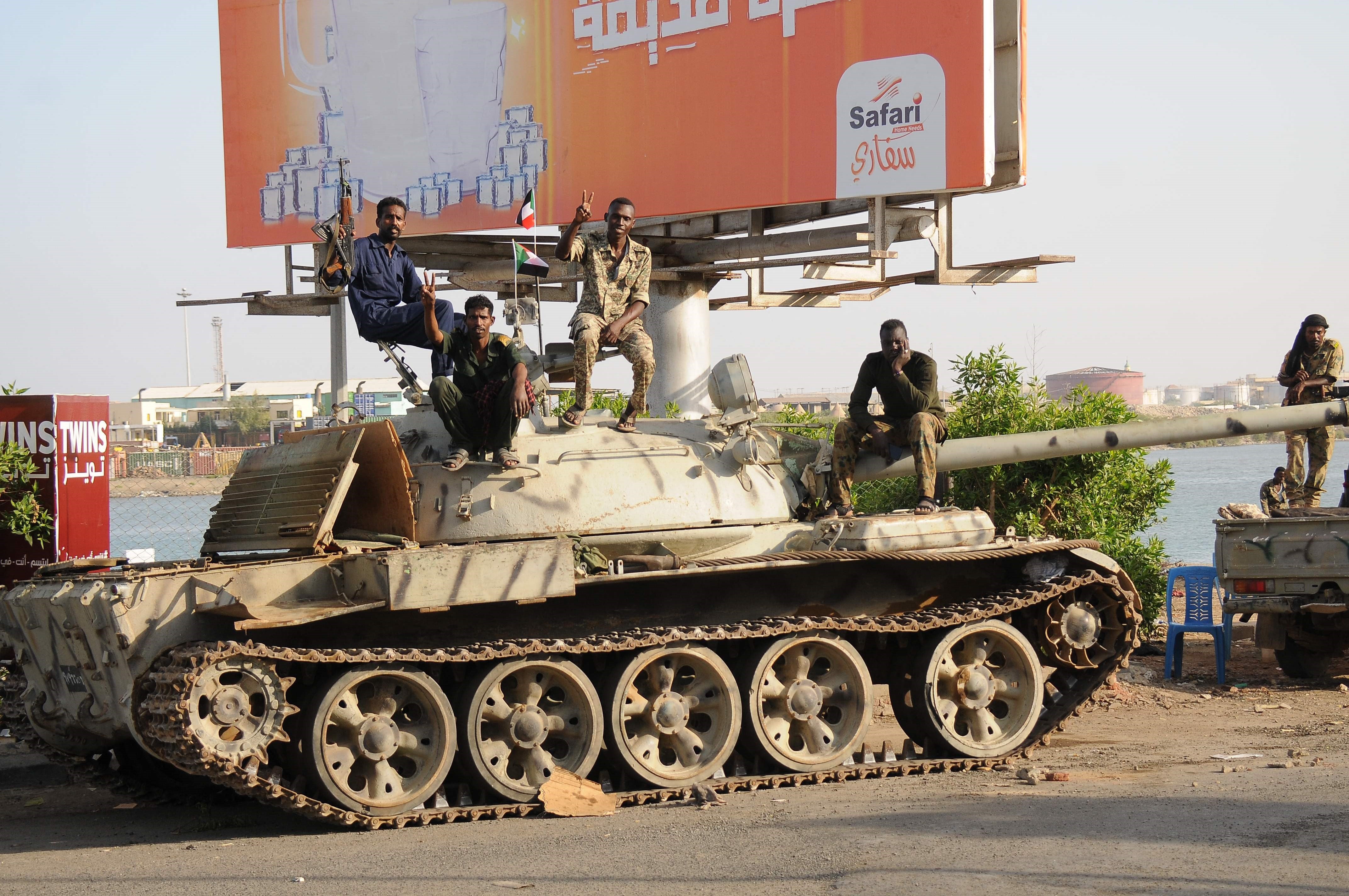 Sudanese soldiers, loyal to army chief Abdel Fattah al-Burhan, sit atop a tank in Port Sudan