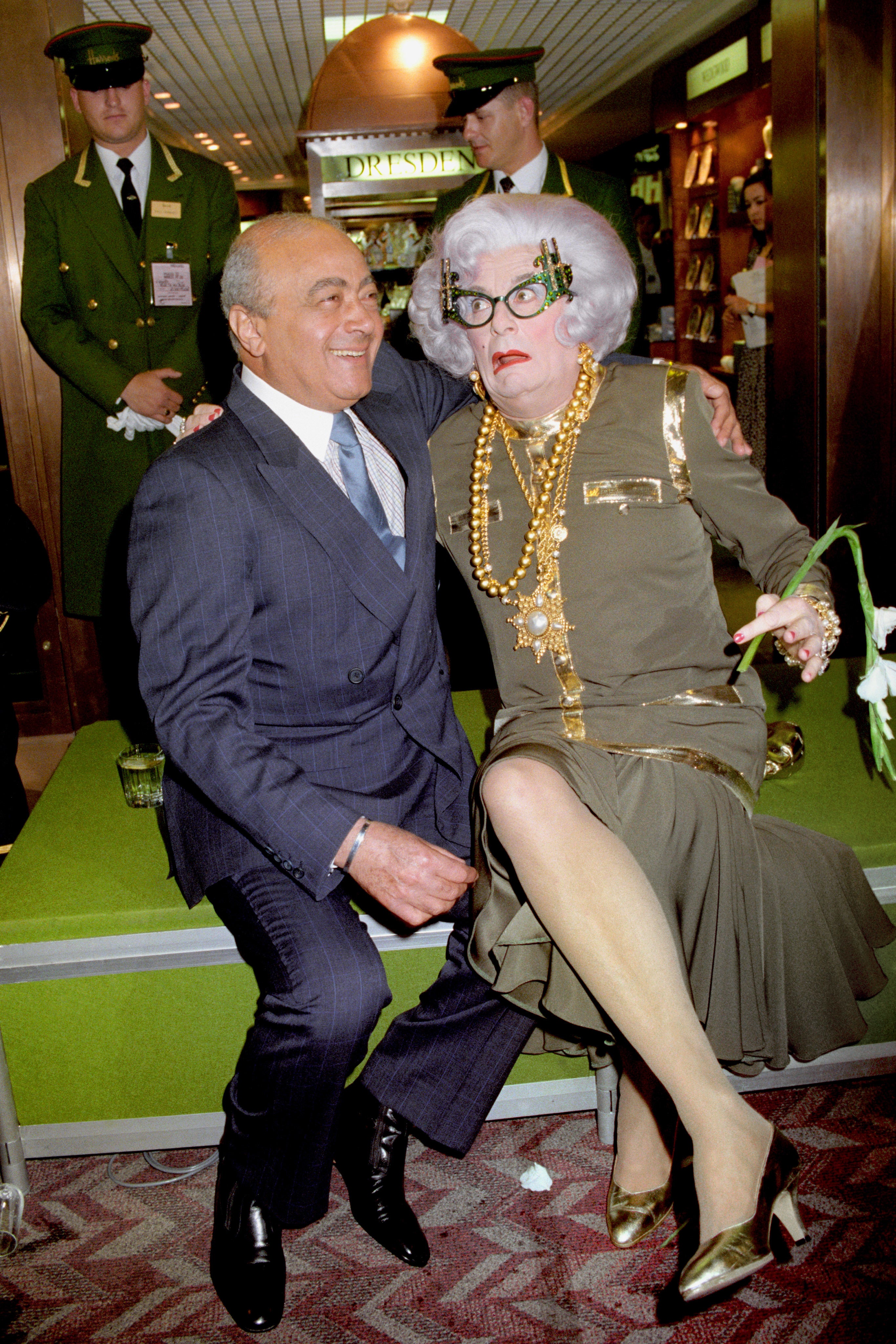 Mohammed Al-Fayed, owner of Harrods, with Dame Edna at the opening of a Harrods Room of Luxury at Heathrow Airport