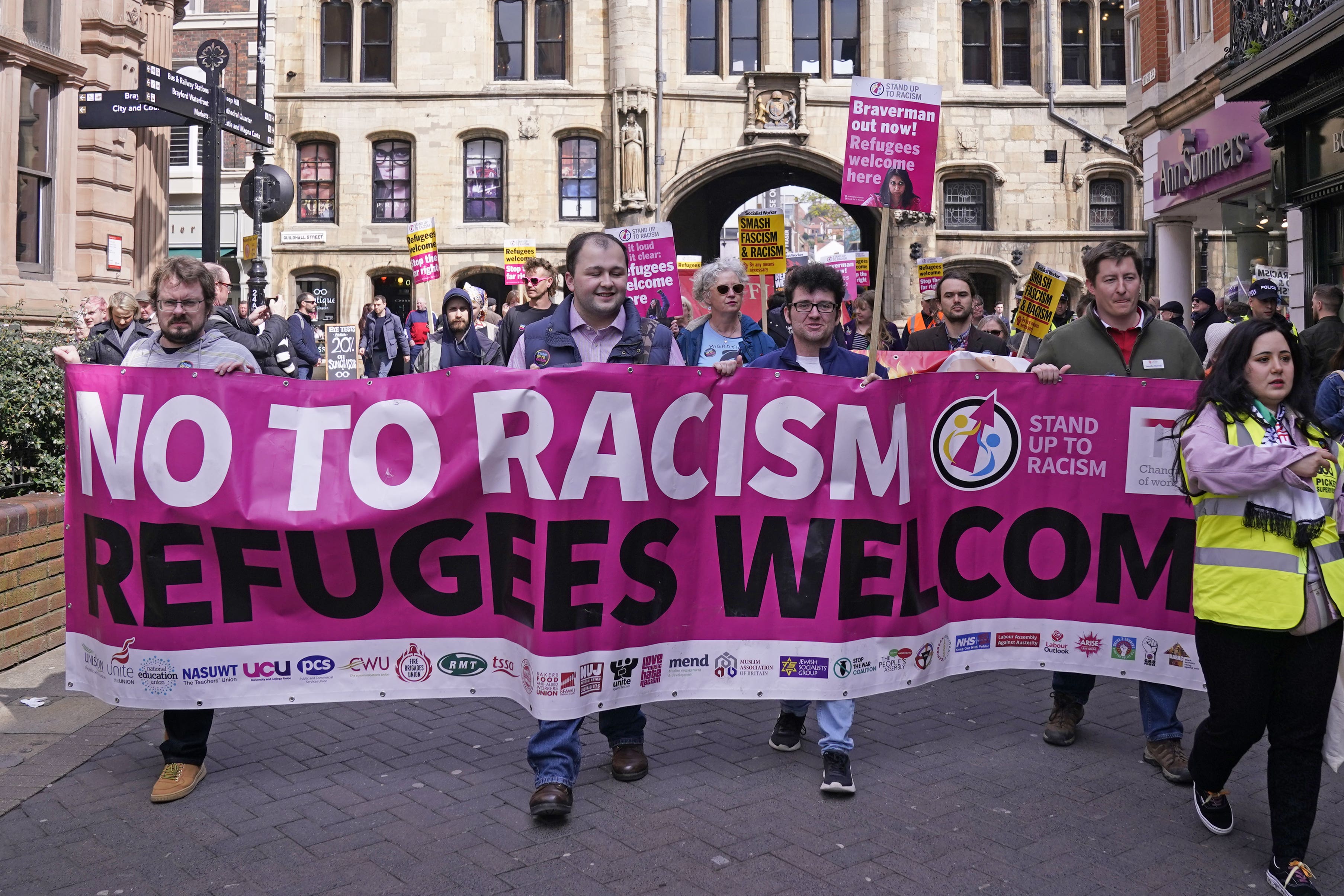 People take part in a rally in Lincoln town centre, supporting the Government’s plan to house migrants at RAF Scampton in Lincolnshire (PA)