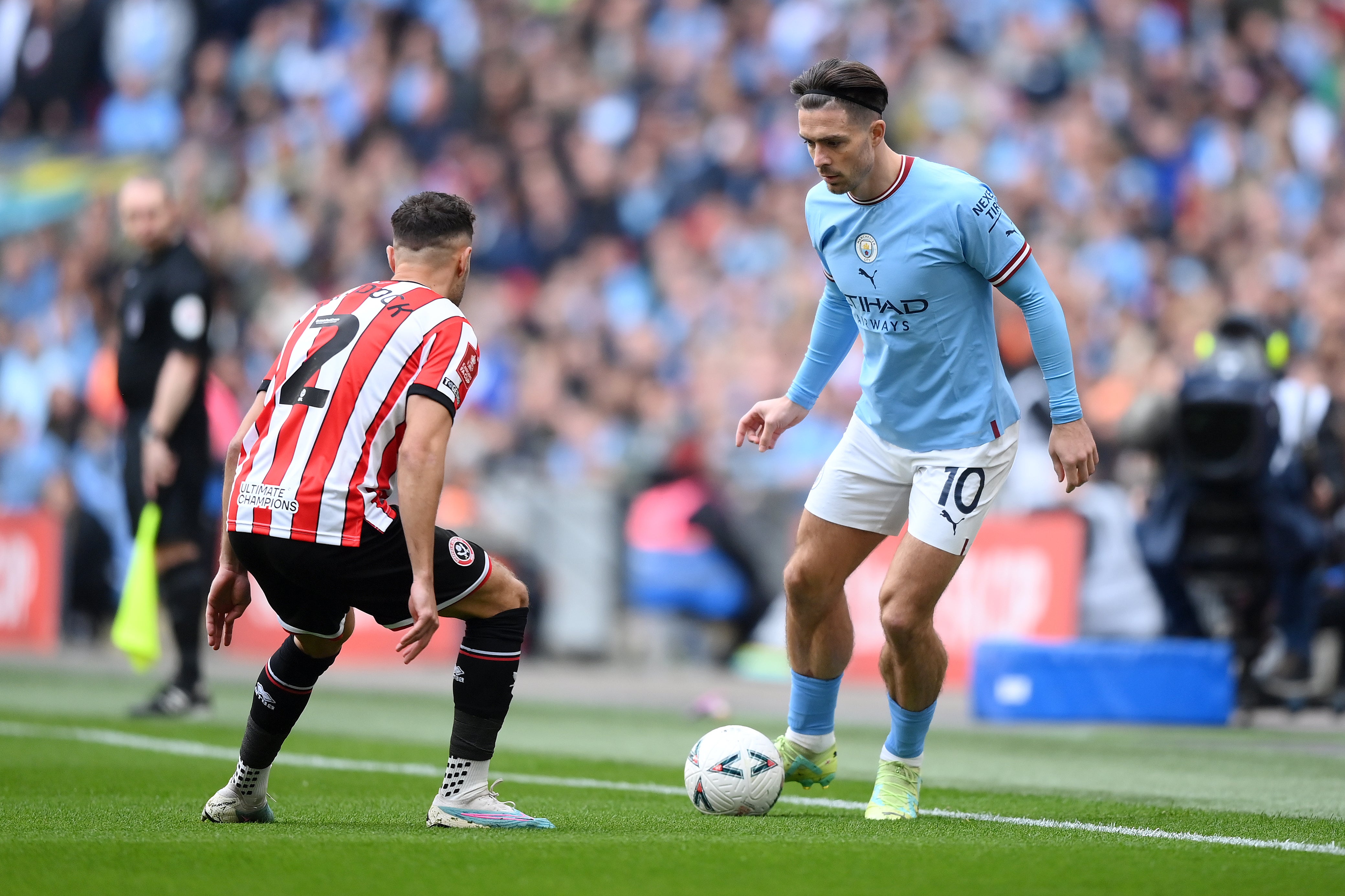 Jack Grealish takes on George Baldock of Sheffield United