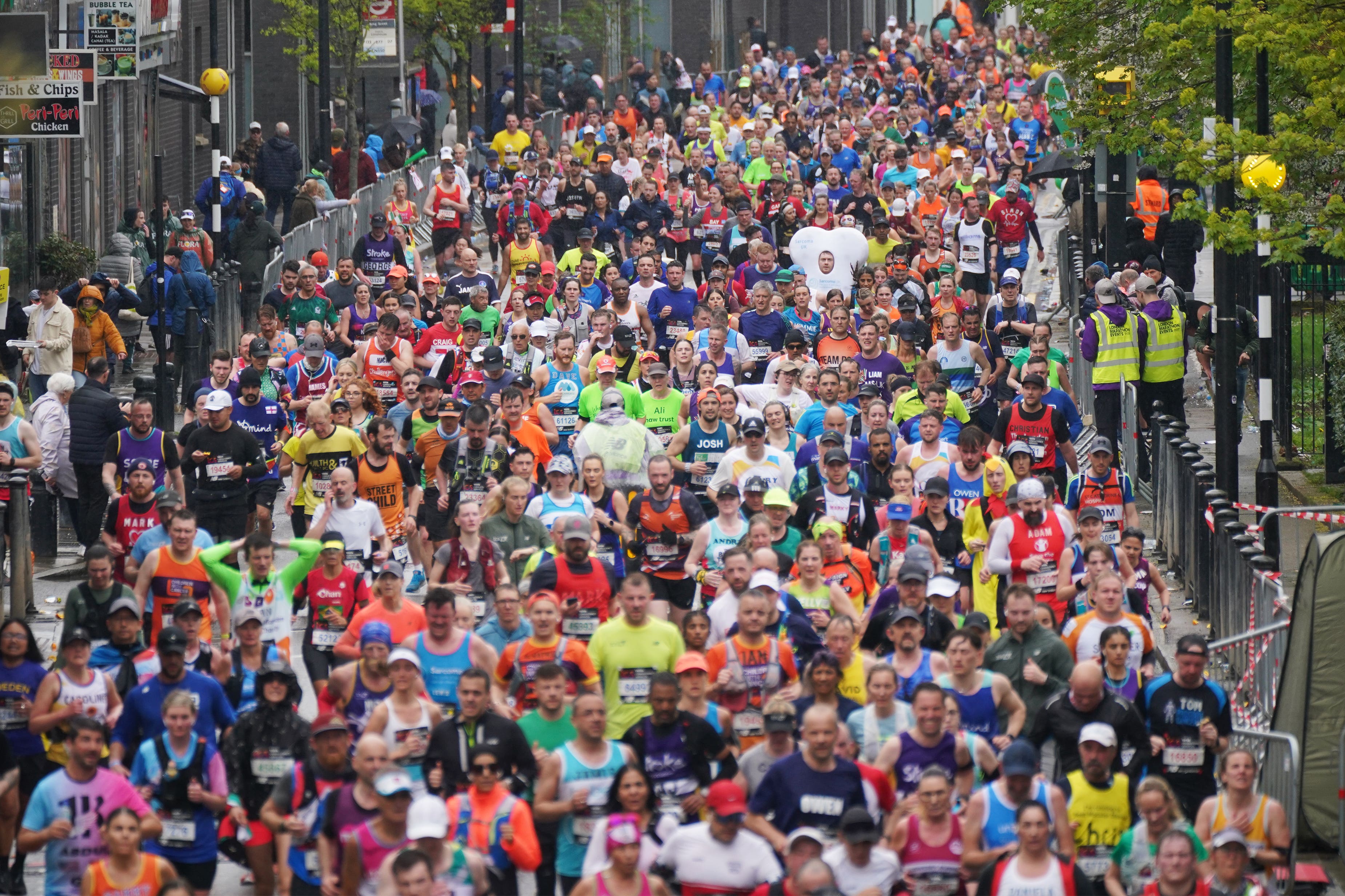 Runners reach the Isle of Dogs during the TCS London Marathon (PA)