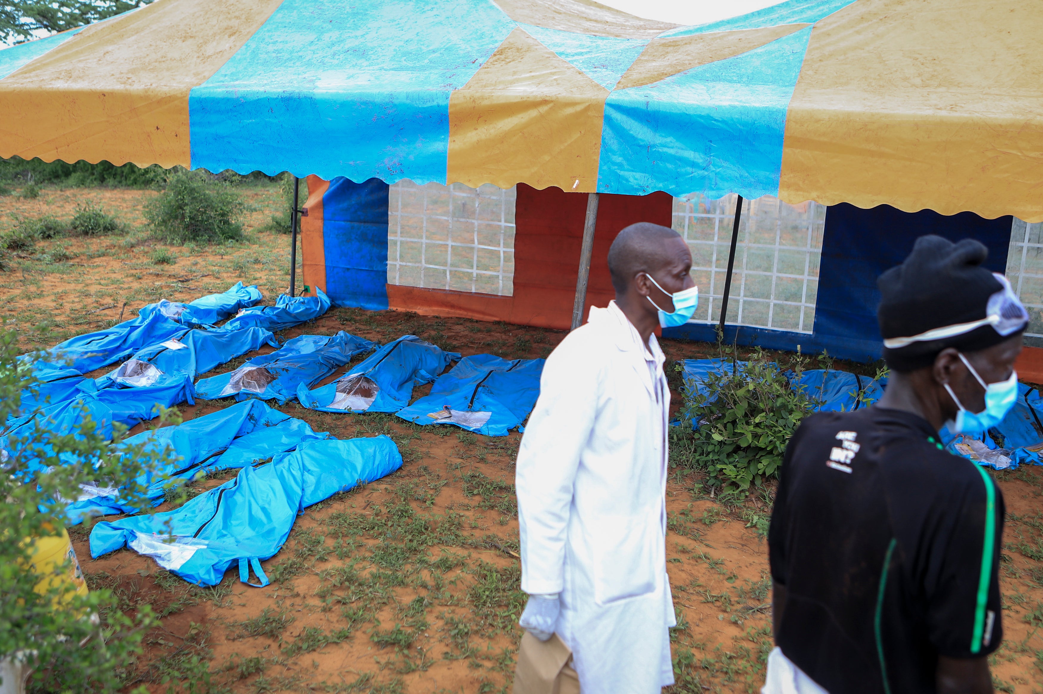 Exhumed bodies are lined in near forest