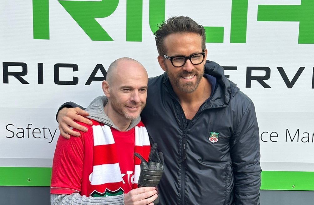 Ryan Reynolds presents Wrexham fan Jay Fear with his glove from Deadpool 2