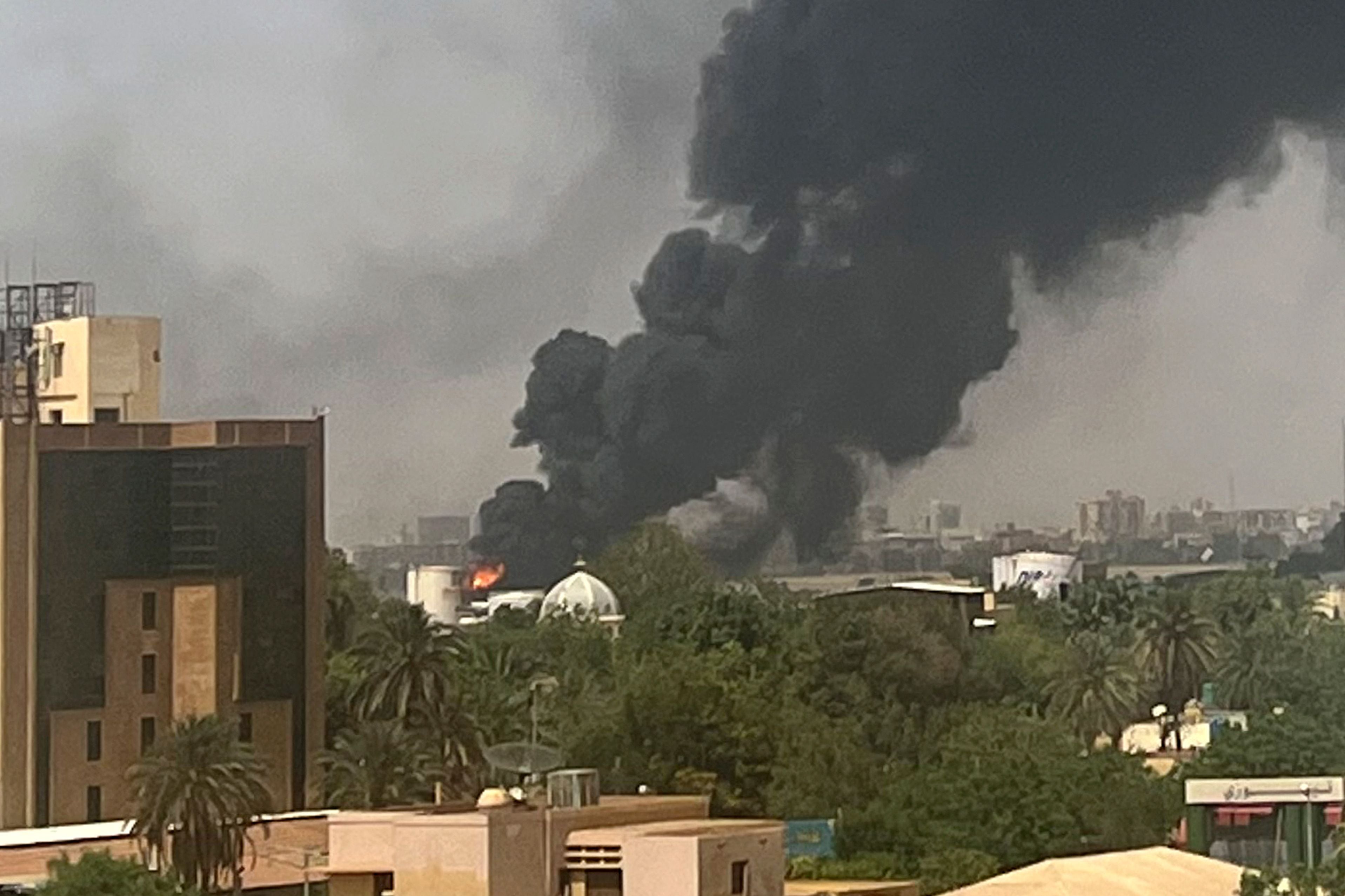 Smoke billows above residential buildings in Khartoum