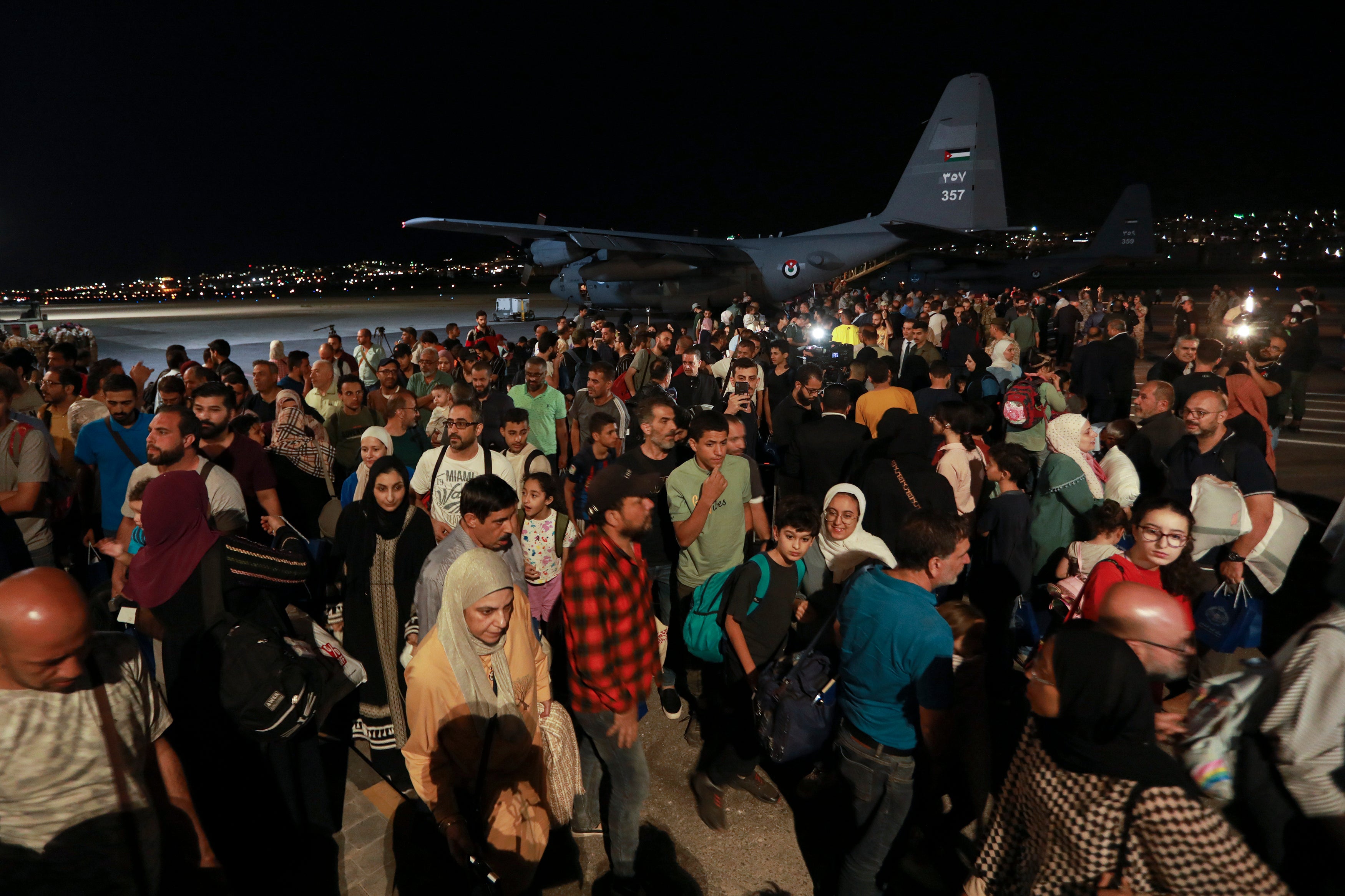 Jordanians evacuated from Sudan arrive at a military airport in Amman